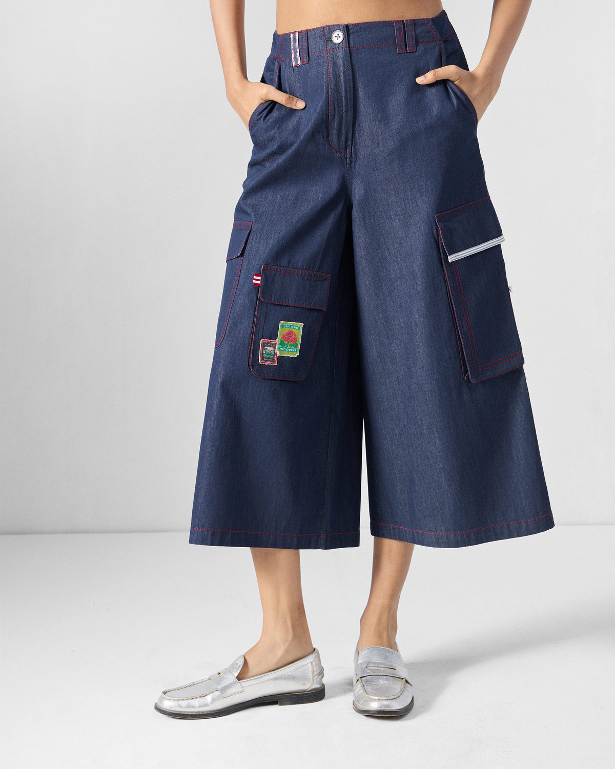 Blue Ella culottes with red contrast stitching and patched cargo pockets.