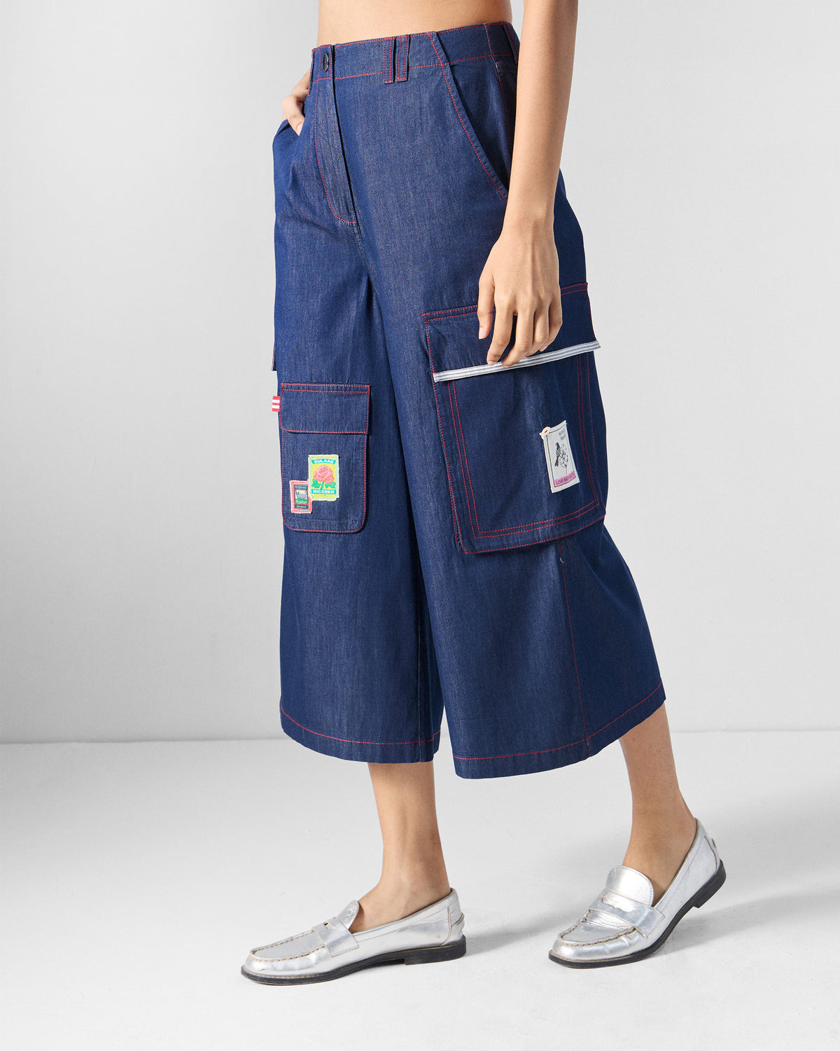 Blue Ella culottes with wide cropped legs, cargo pockets, and red stitching.