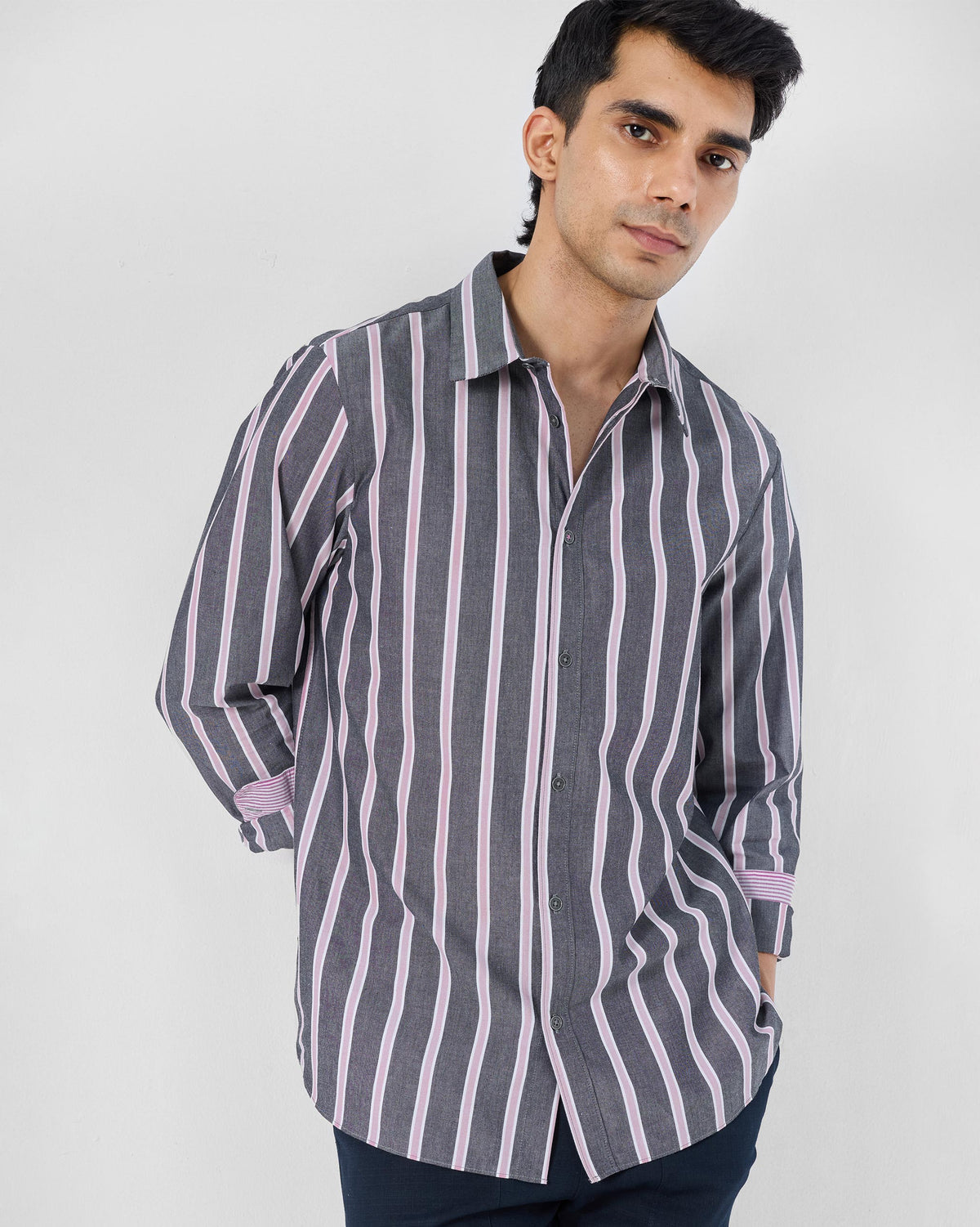 Person wearing an untucked charcoal and pink striped Classic shirt.