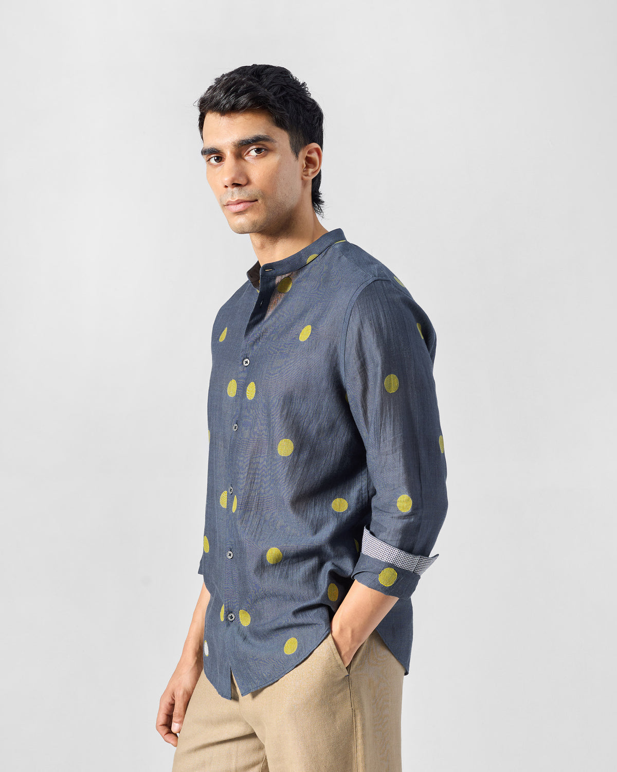 Three-quarter view of a charcoal Nawab Shirt with large chartreuse polka dots.