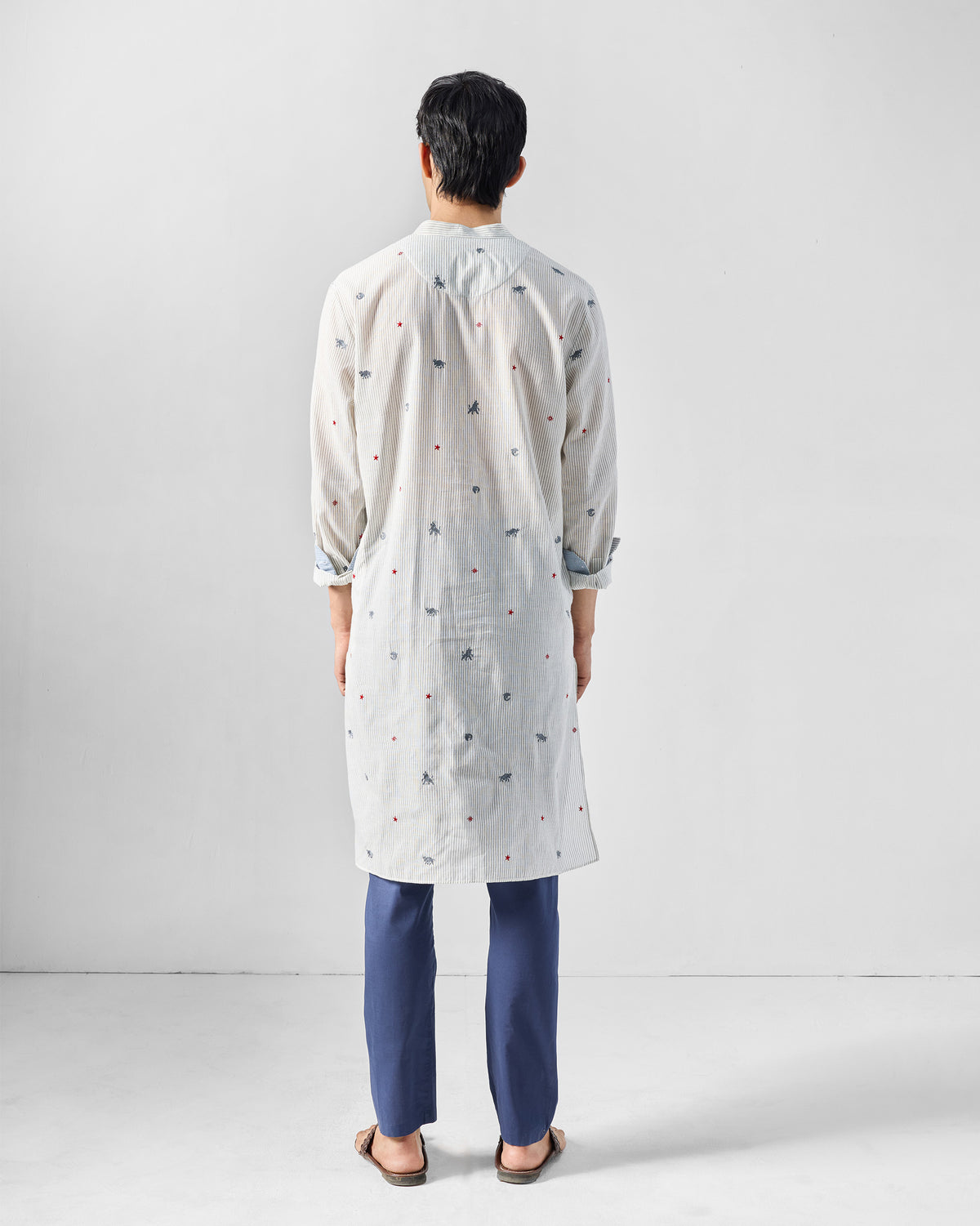 Back of a charcoal and white Bageecha kurta with animal embroidery.
