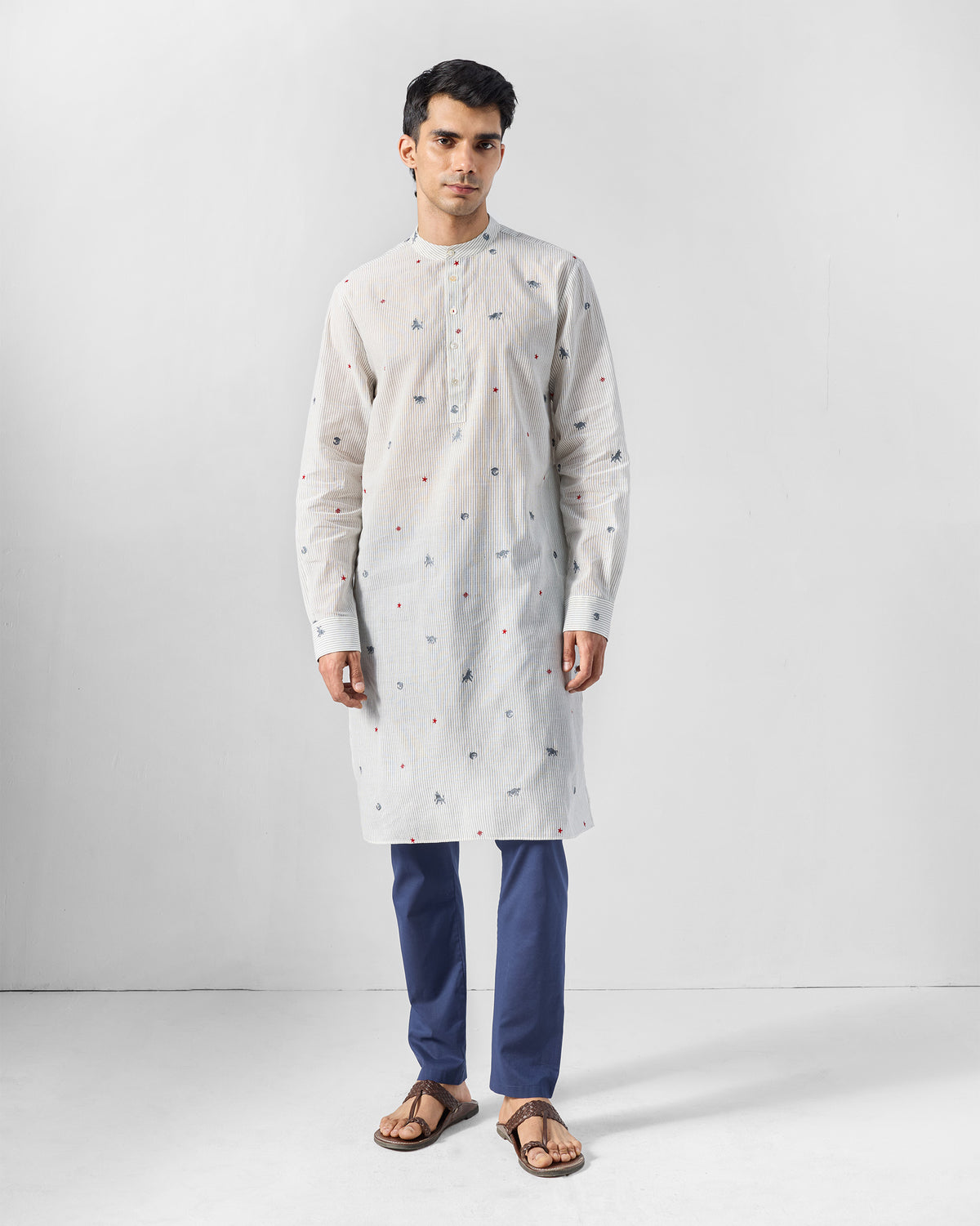 Person wearing a charcoal and white Bageecha kurta with animal embroidery.