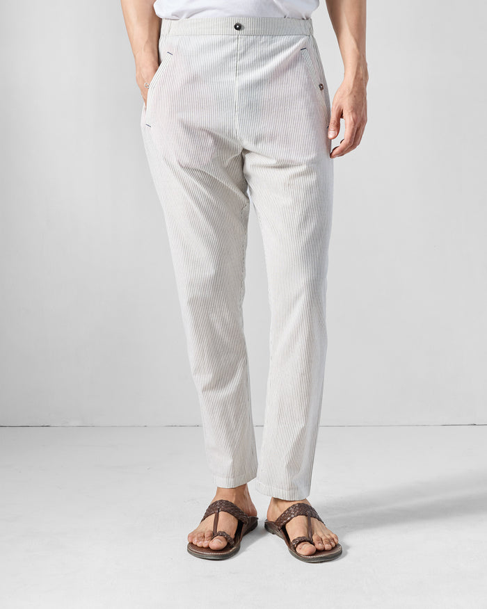 Person wearing charcoal and white striped Kurta Pants with a flat front.