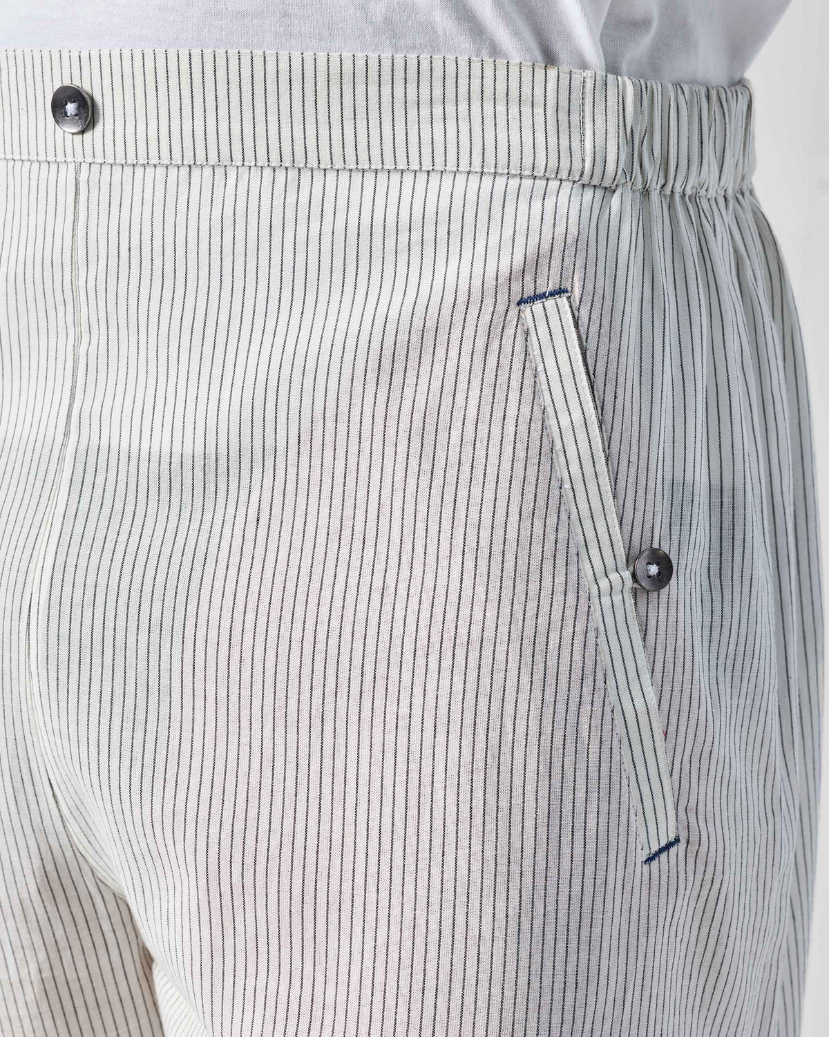 Close-up of charcoal and white striped Kurta Pants showing the pocket and bar tacks.