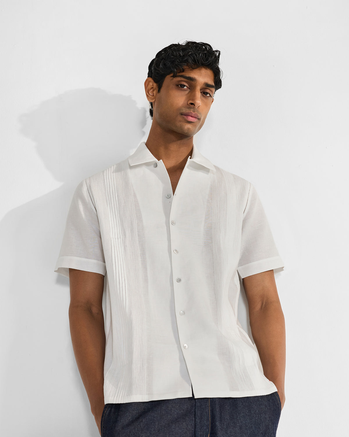Person wearing a white Egret shirt with vertical pintuck panels.