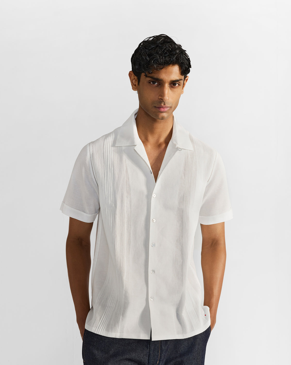 Person wearing a white Egret shirt with graded front pintucks.
