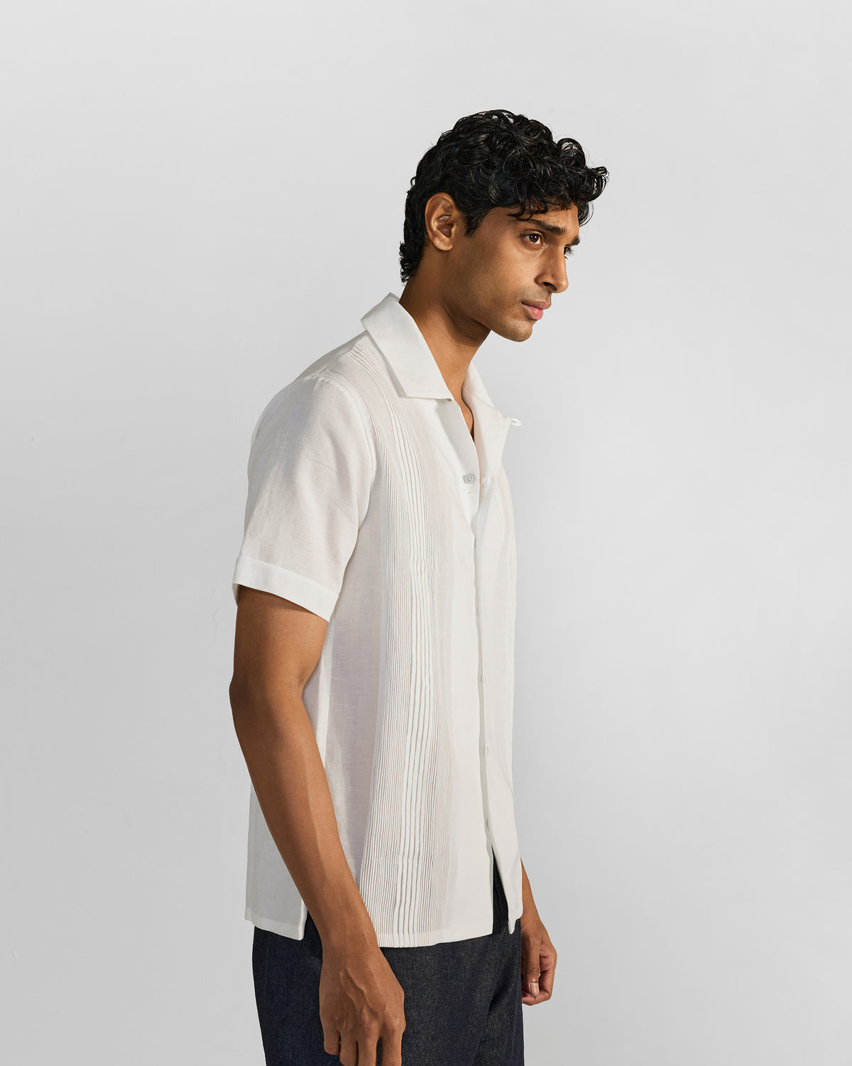 Side view of a white Egret shirt with front pintuck panels.