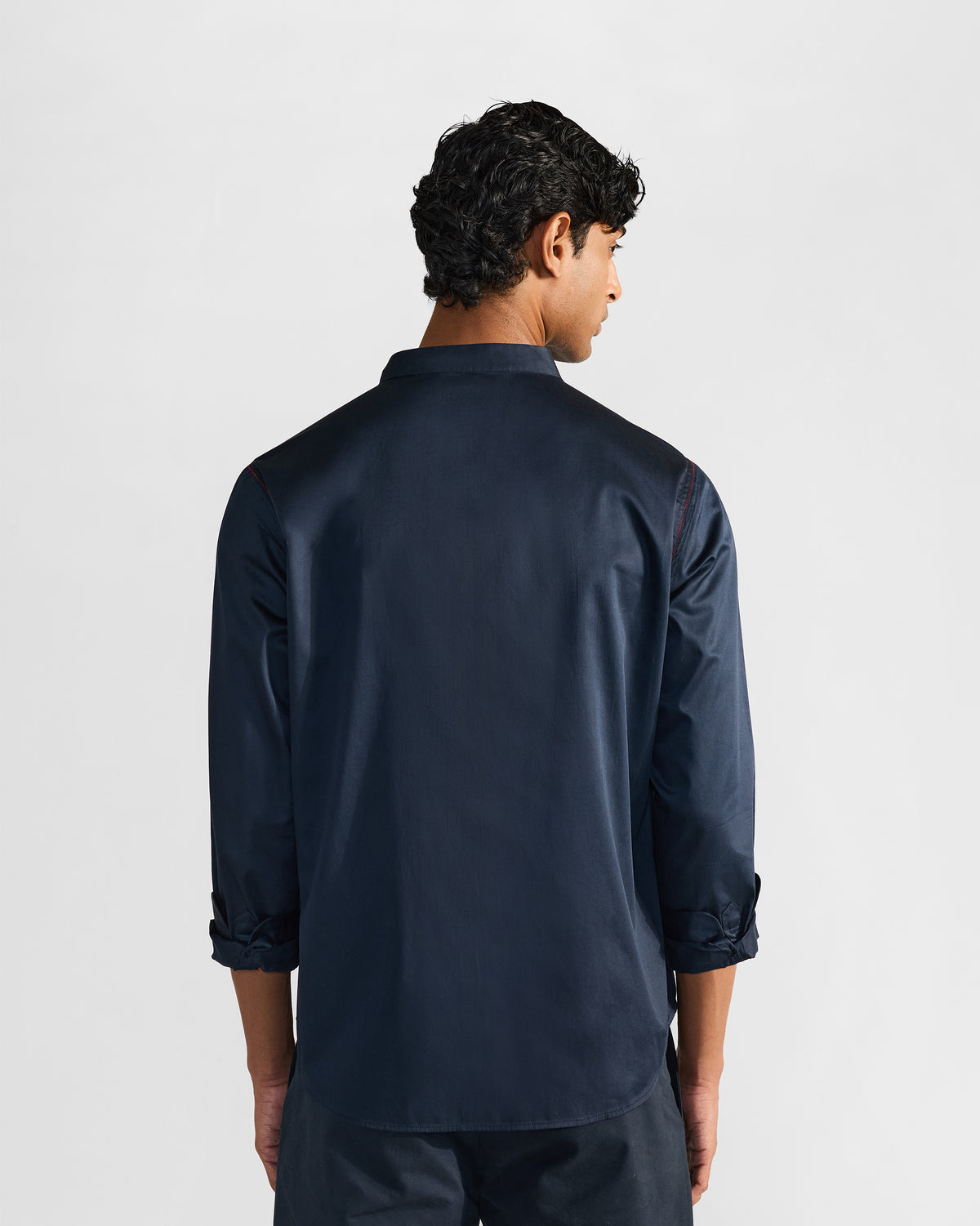 Back of a navy Nightjar shirt worn by a person.