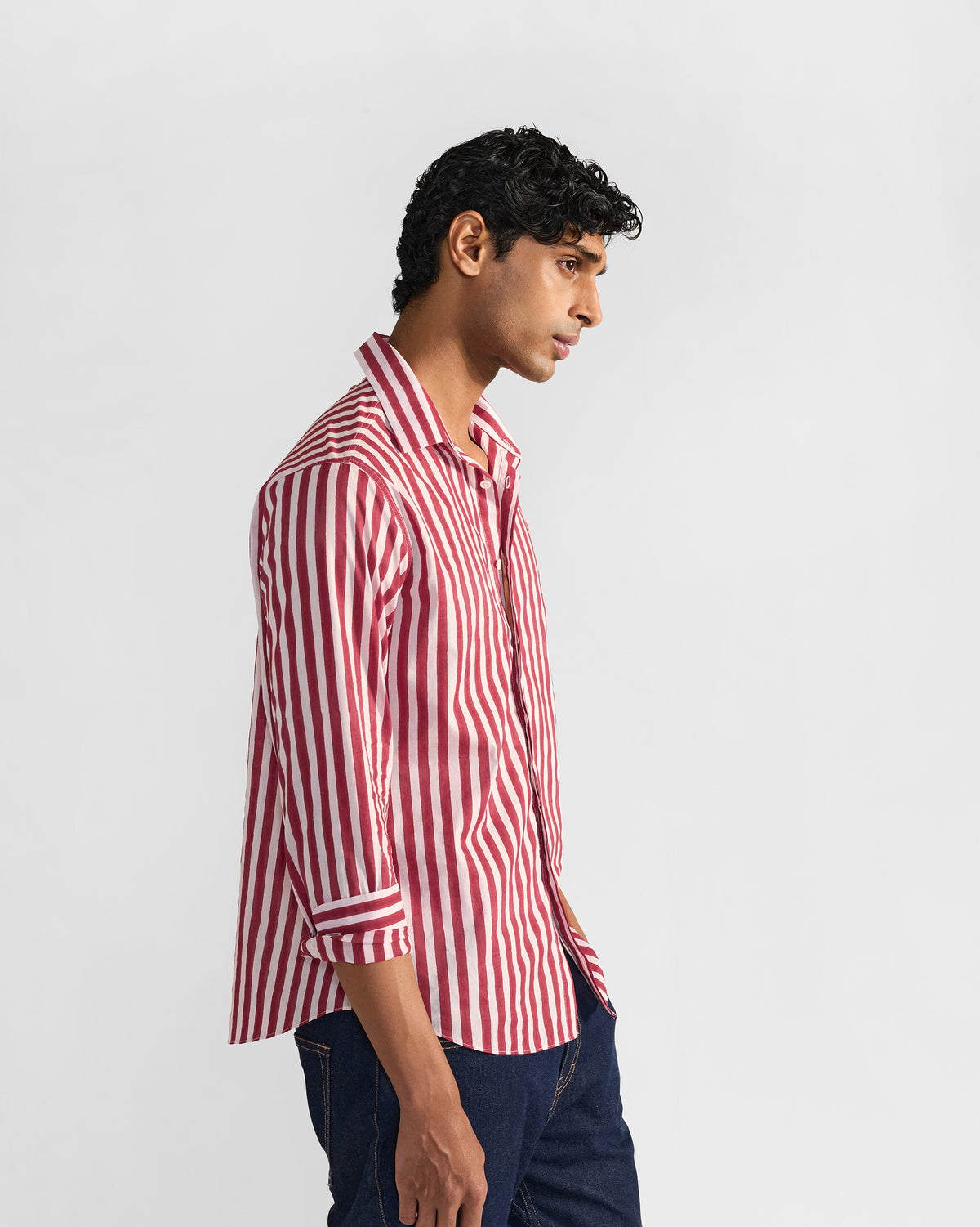 Side profile of a red and white striped Civet shirt with rolled sleeves.