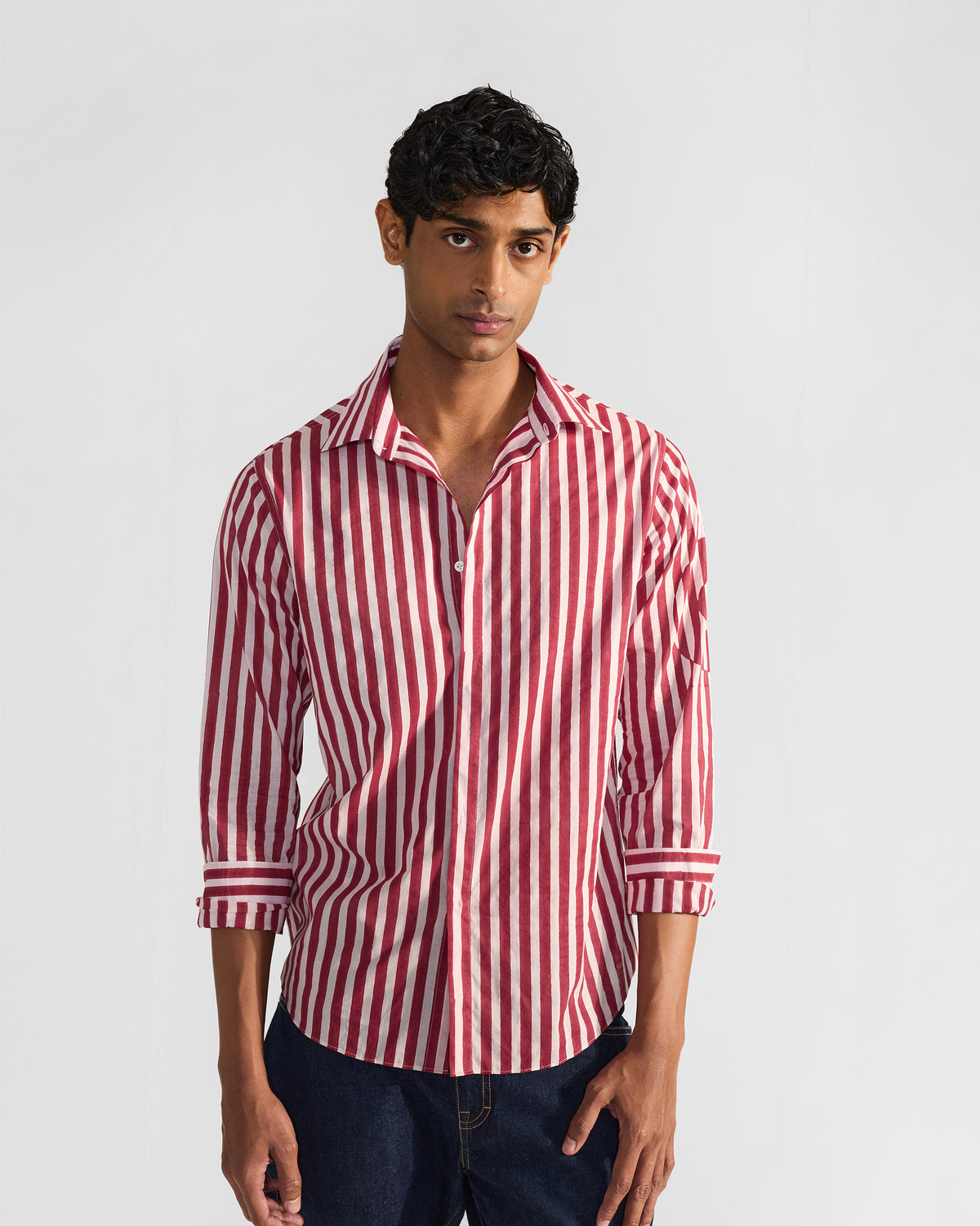 Person wearing a red and white striped Civet shirt with an open collar.