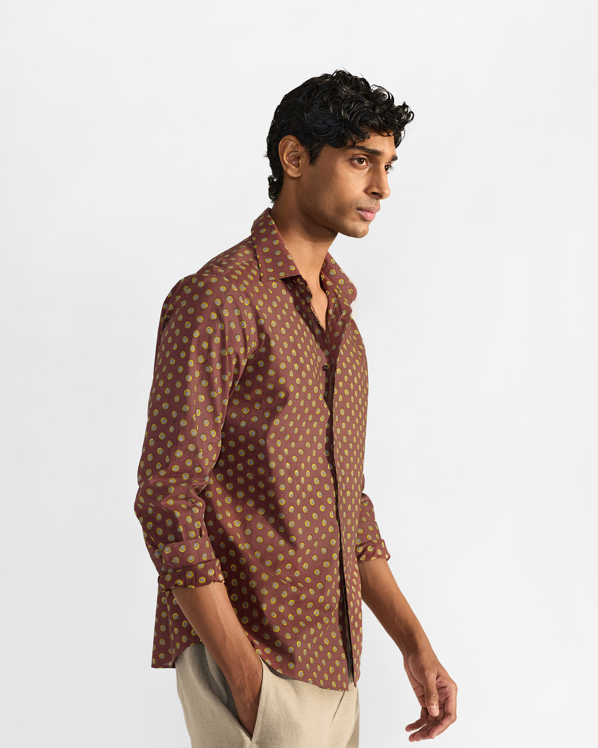 Side view of a brown Pipit Shirt with a lime circular print.