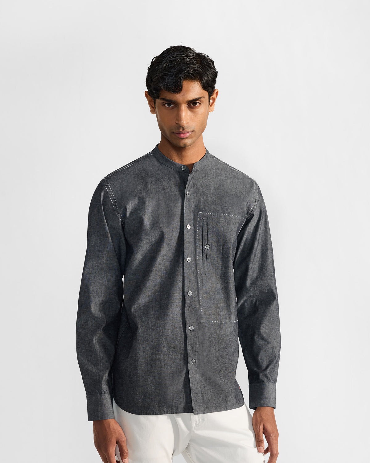 Person wearing a charcoal Marten shirt with a band collar and chest pocket.