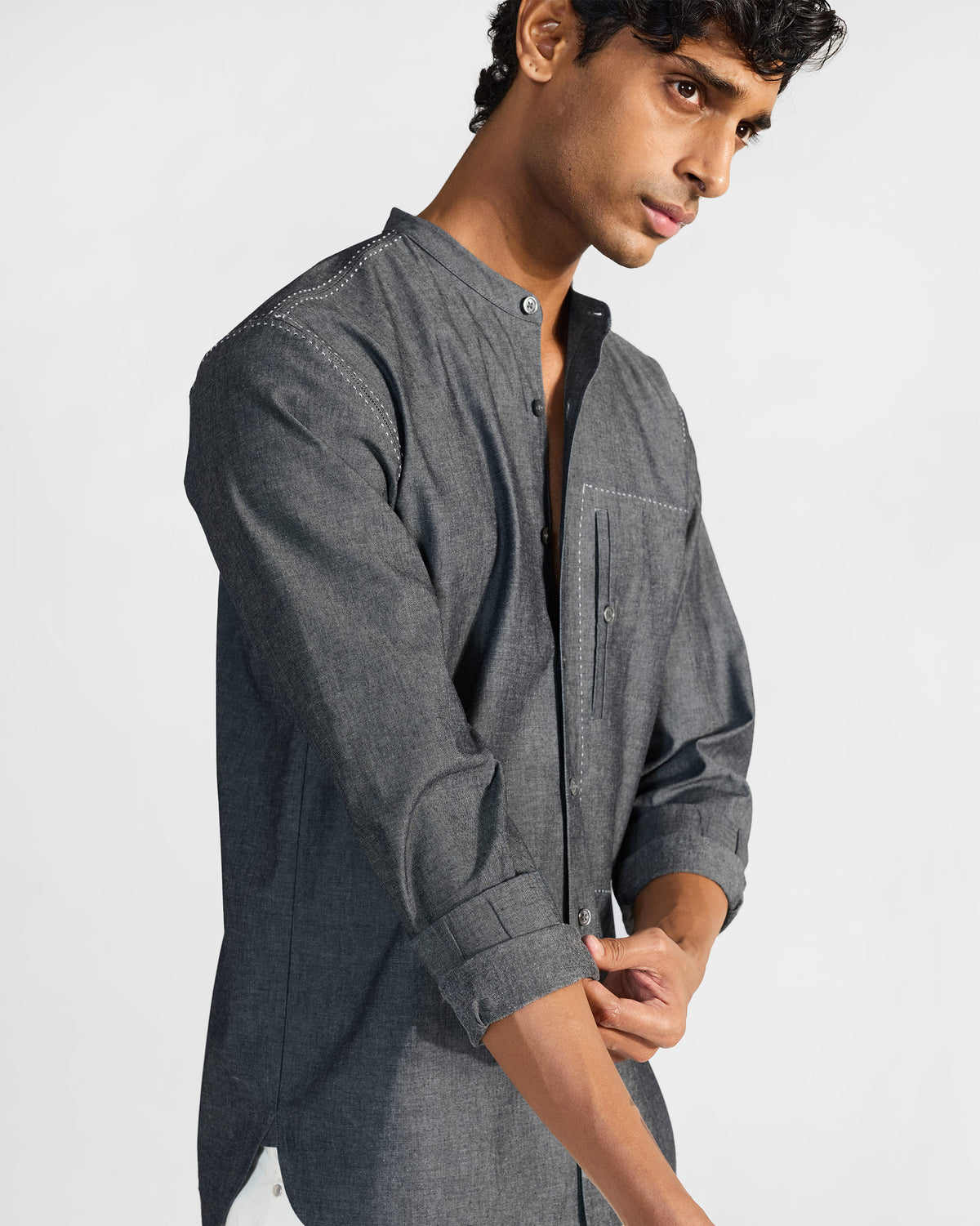 Side view of a charcoal Marten shirt with white contrast stitching.