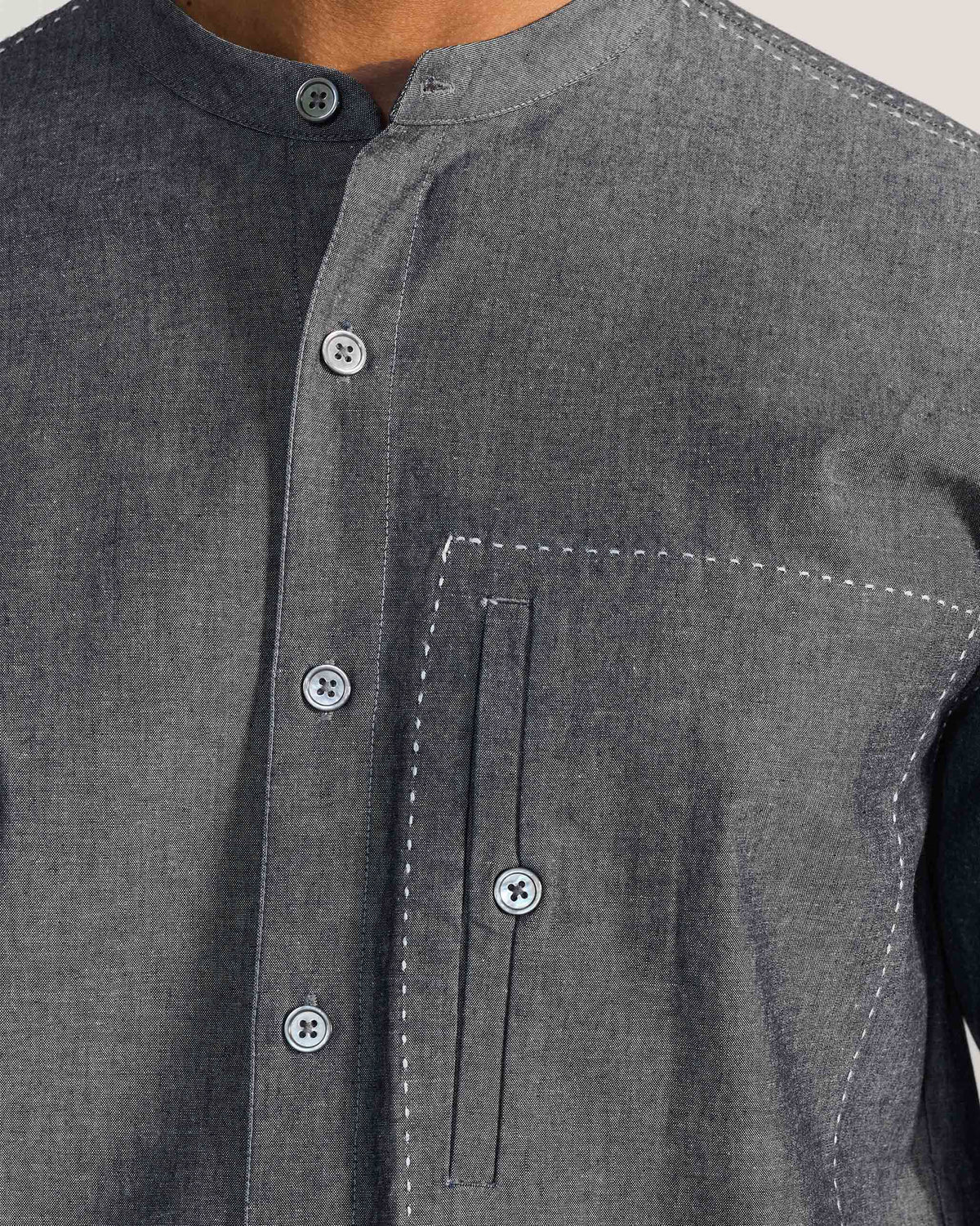 Close-up of the band collar and stitched chest pocket on a charcoal Marten shirt.