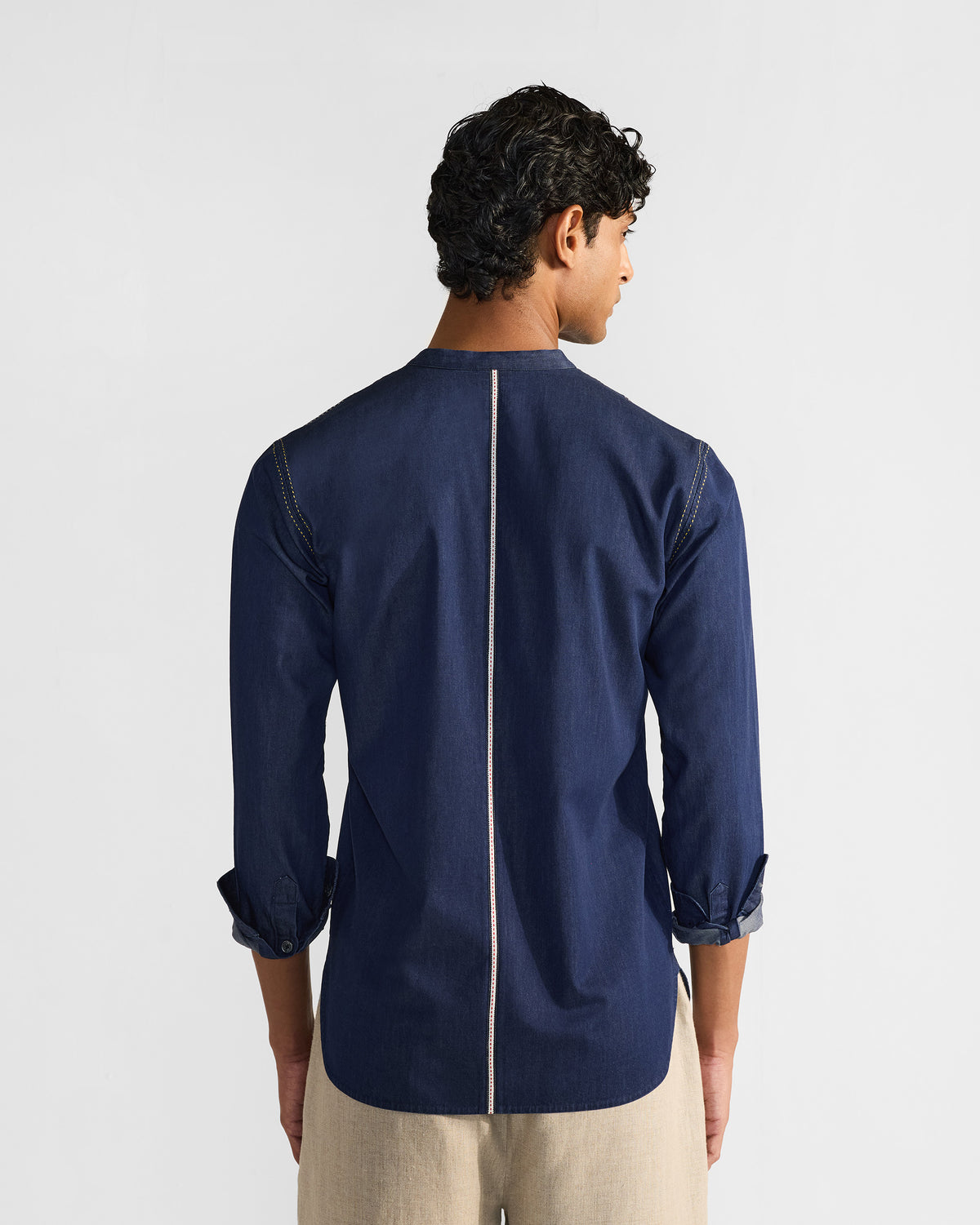 Back of an indigo Loris shirt with a cream centre stripe.