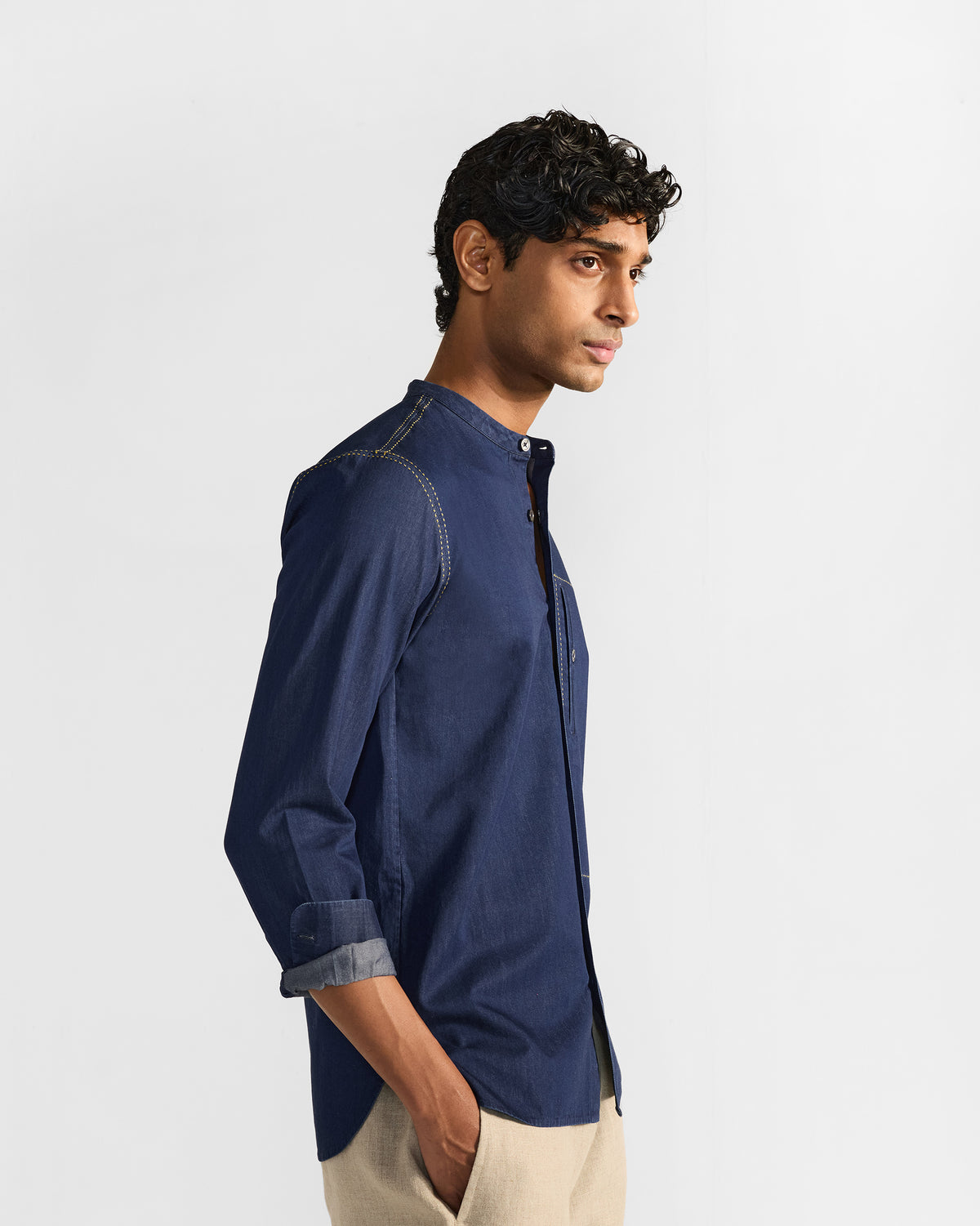 Side view of an indigo Loris shirt with contrast stitching.