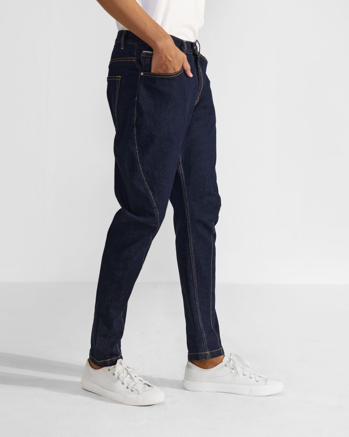 Side view of denim Robin Jodhpur Pants showing the curved seam and taper.