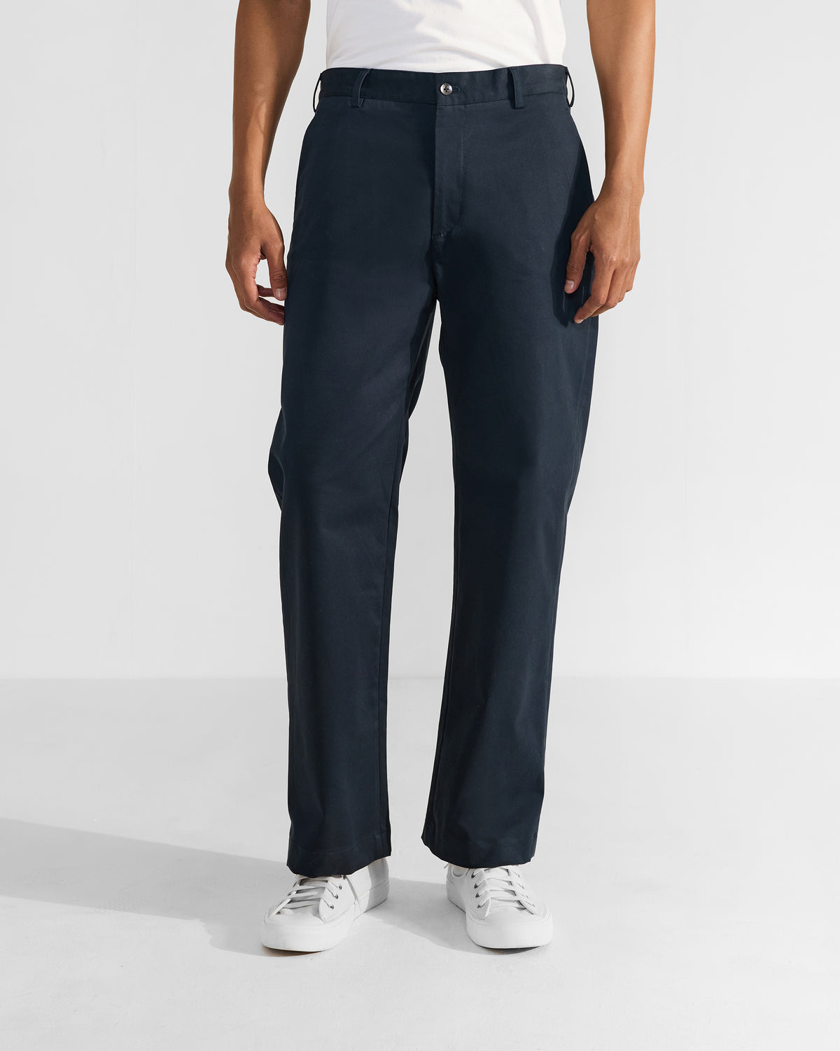 Person wearing navy Flycatcher Trousers with a straight leg and side pockets.