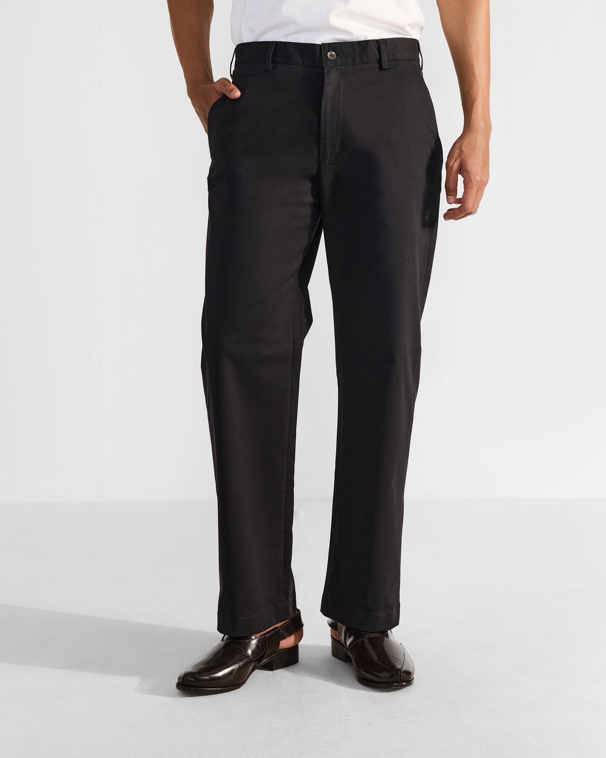 Person wearing black Panther Trousers with a straight leg and side pockets.