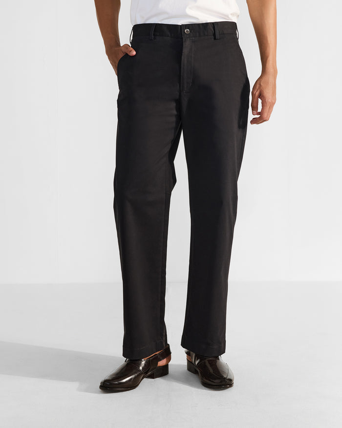 Person wearing black Panther Trousers with a straight leg and side pockets.