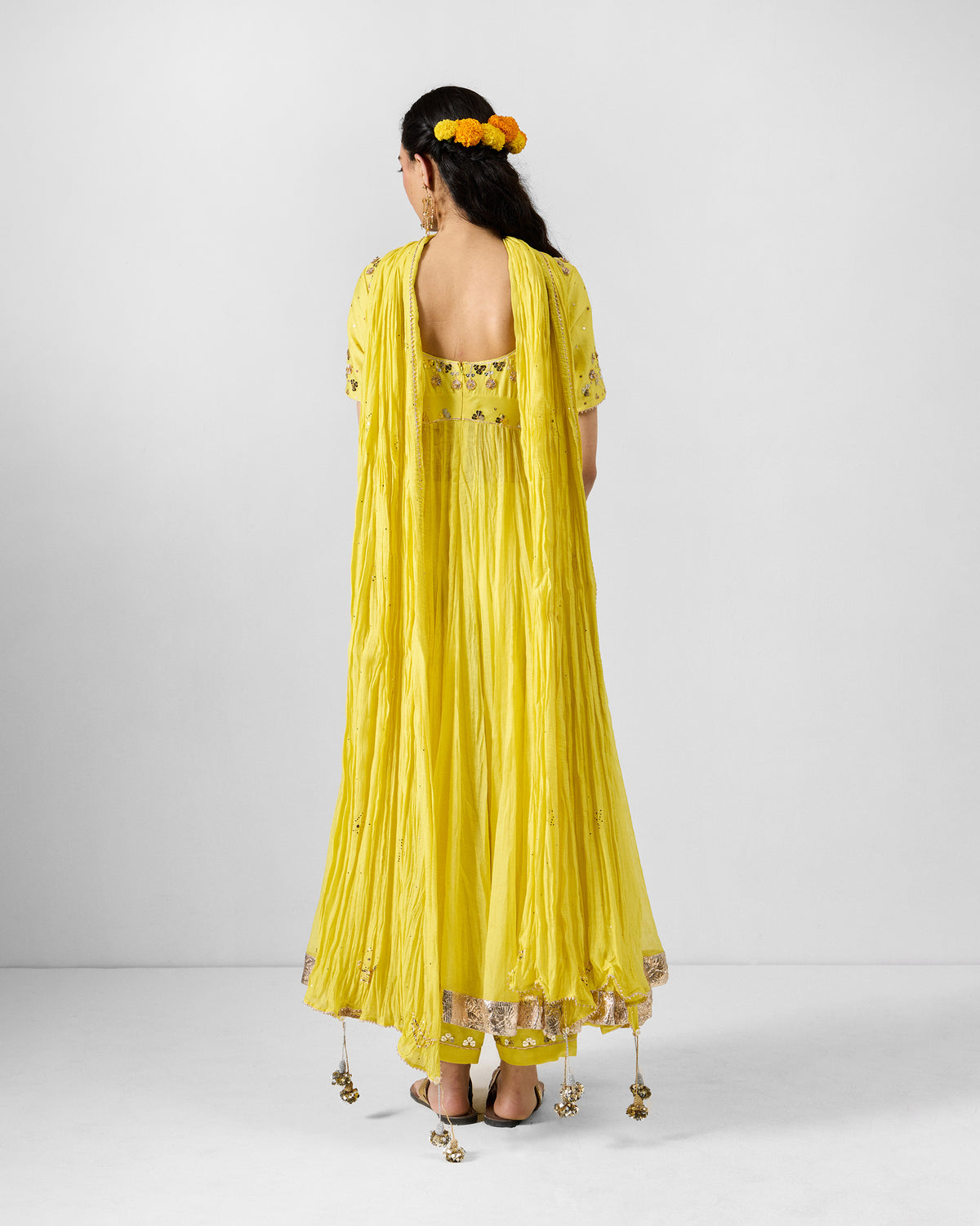 Yellow embroidered Shanti dupatta draped over the shoulders from the back.