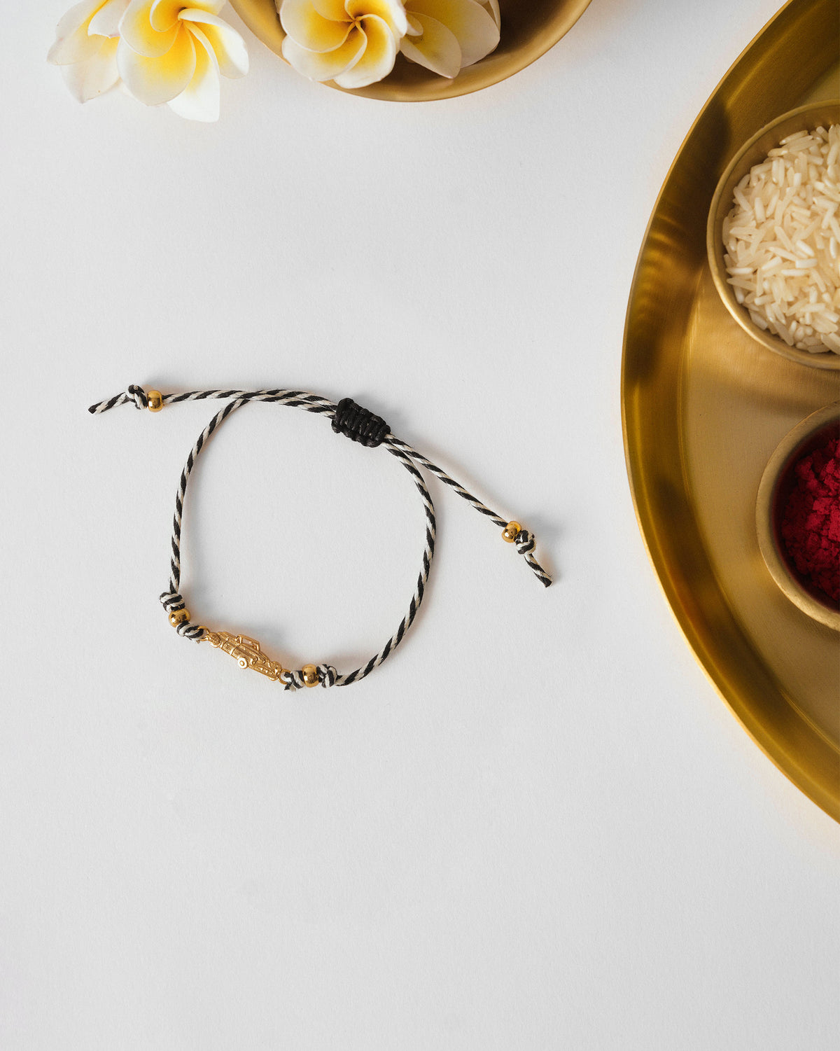 Vintage Car Rakhi in charcoal and white stripes, laid flat.