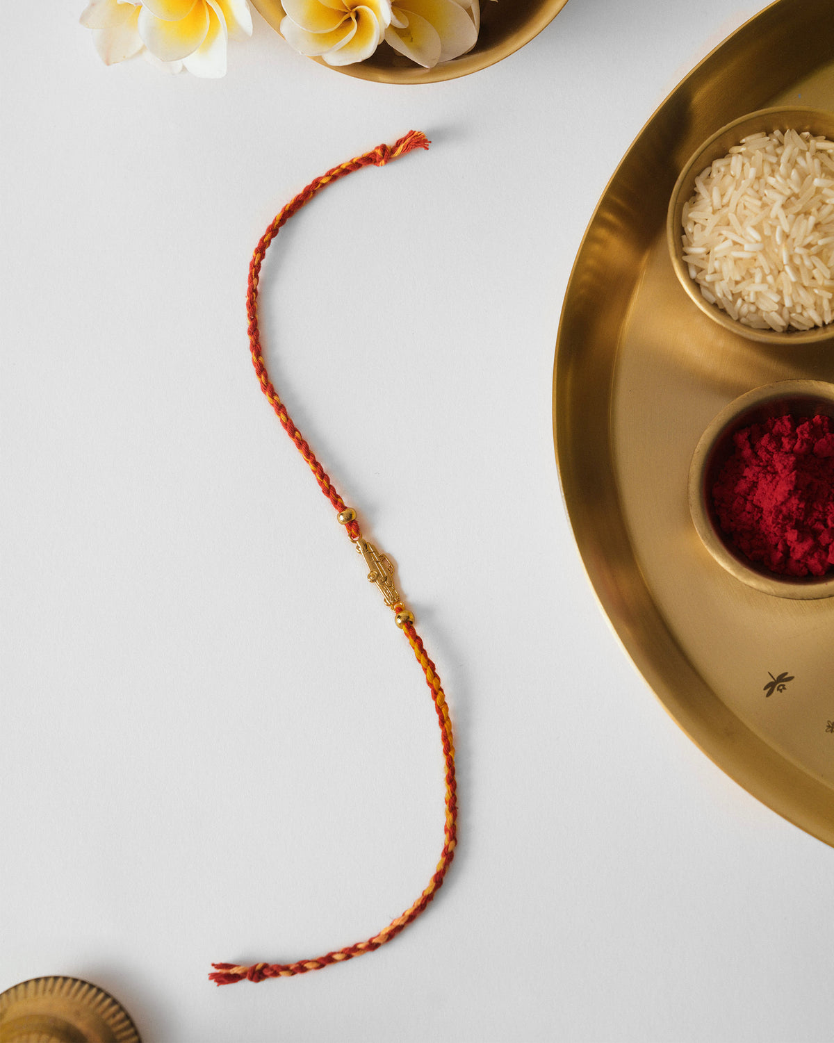 Vintage Car Rakhi in red, laid flat.