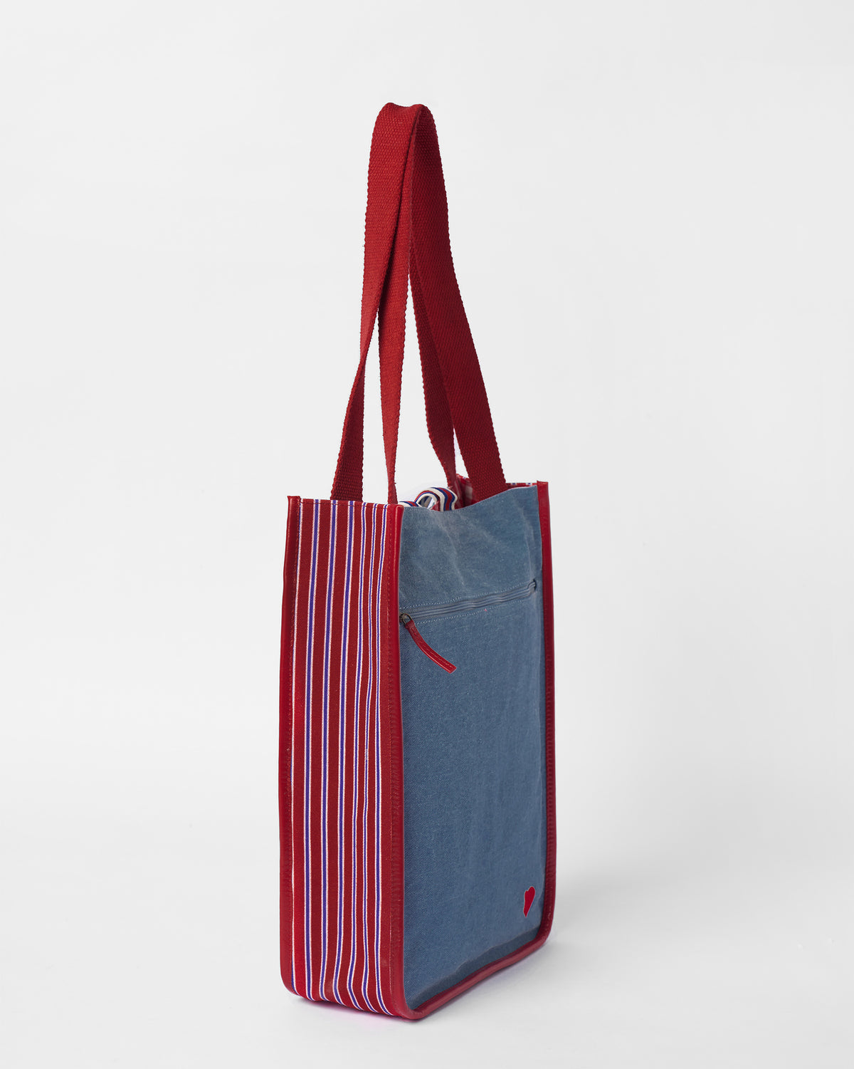 Blue Nico Matchbox tote with a striped gusset and red straps.