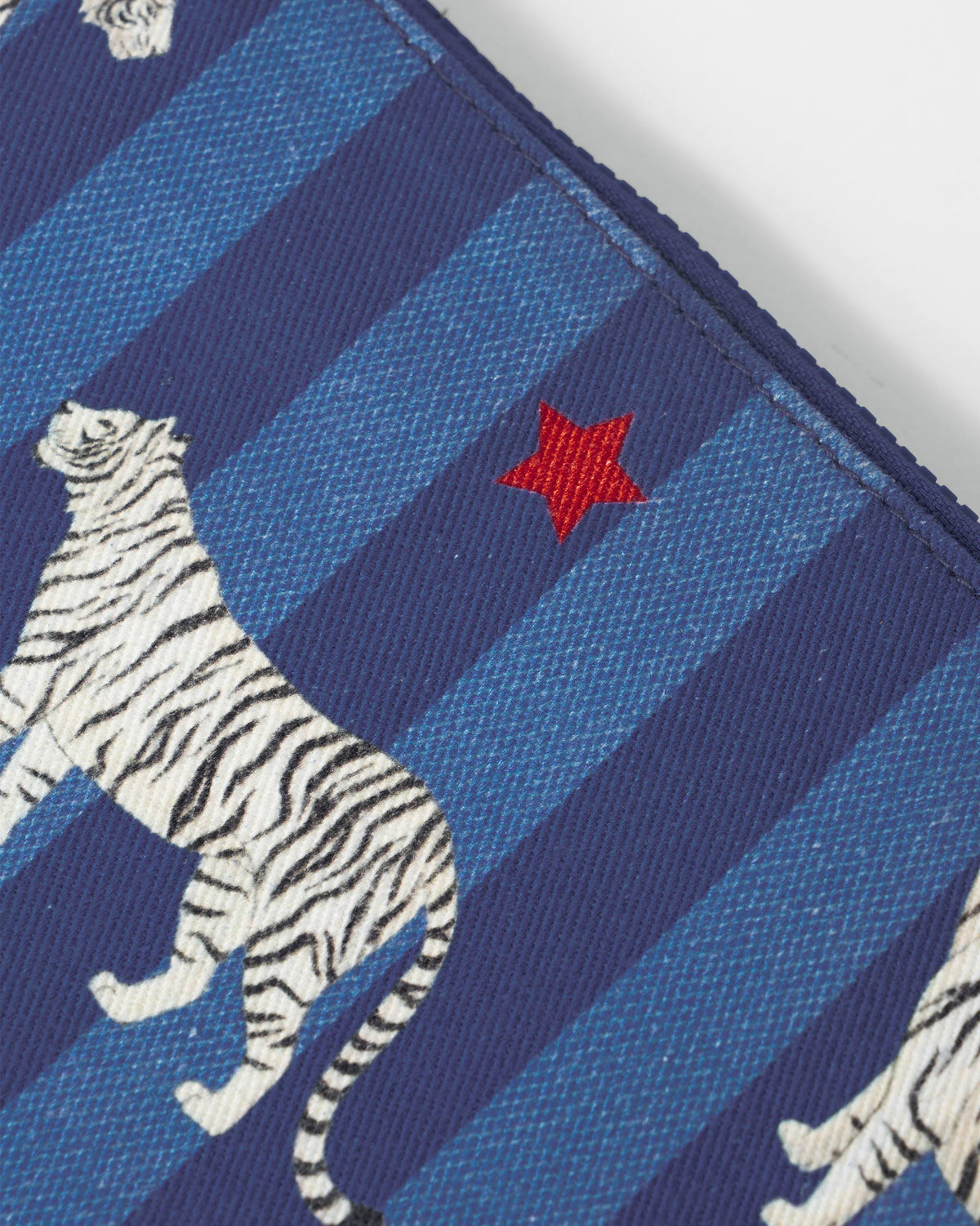 Close-up of the Berber Laptop Sleeve showing a white tiger and red star.