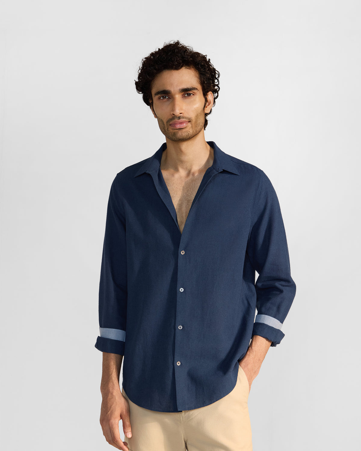 Navy Rewa shirt with an open collar and pale cuff lining.