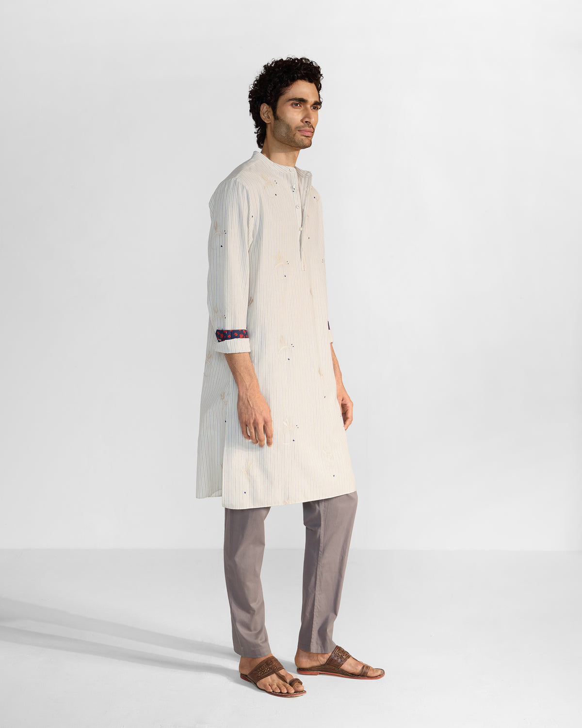 Side view of an ivory Astral kurta with navy and ivory stripes.