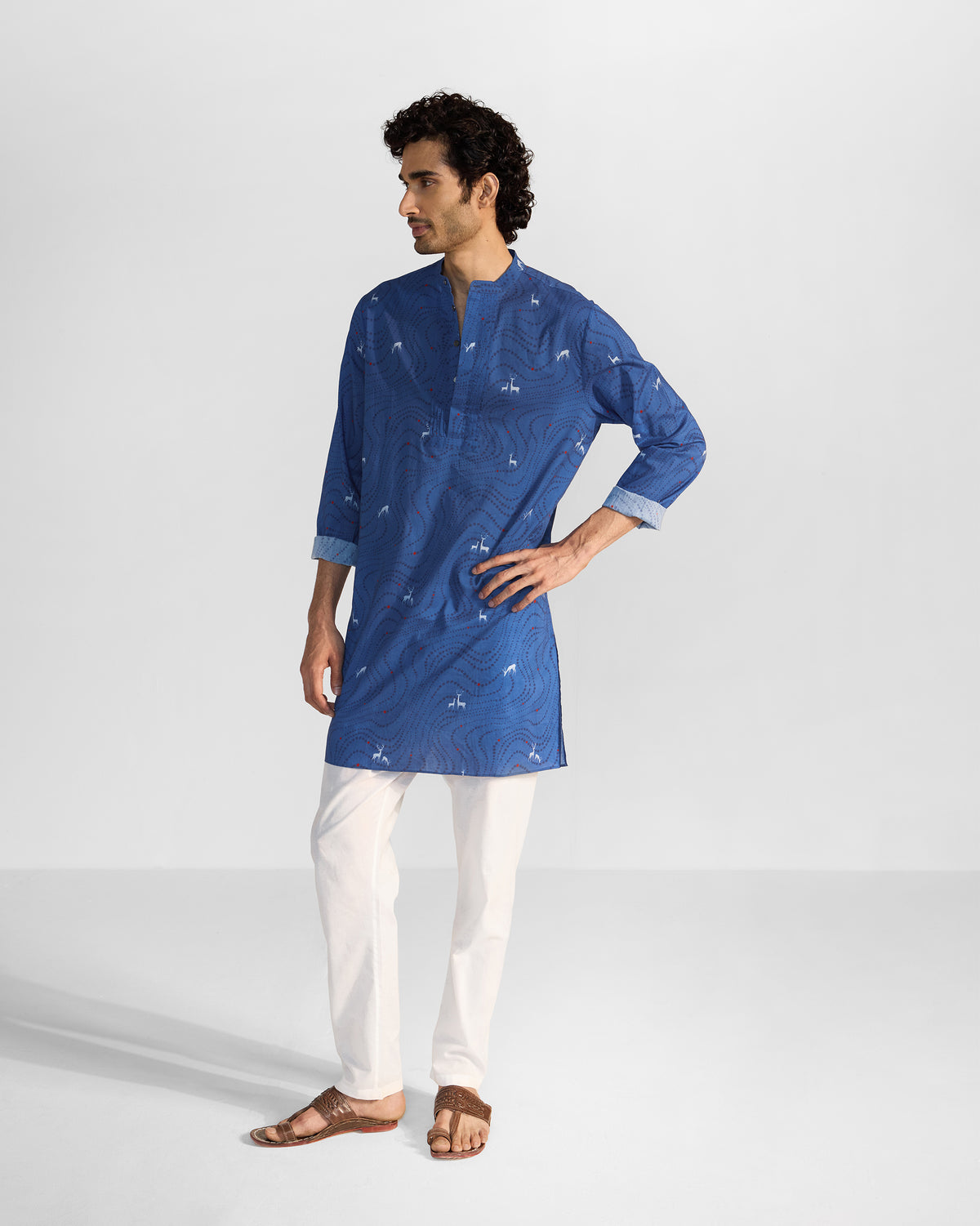Person wearing a blue Front Pleat kurta with white deer print.