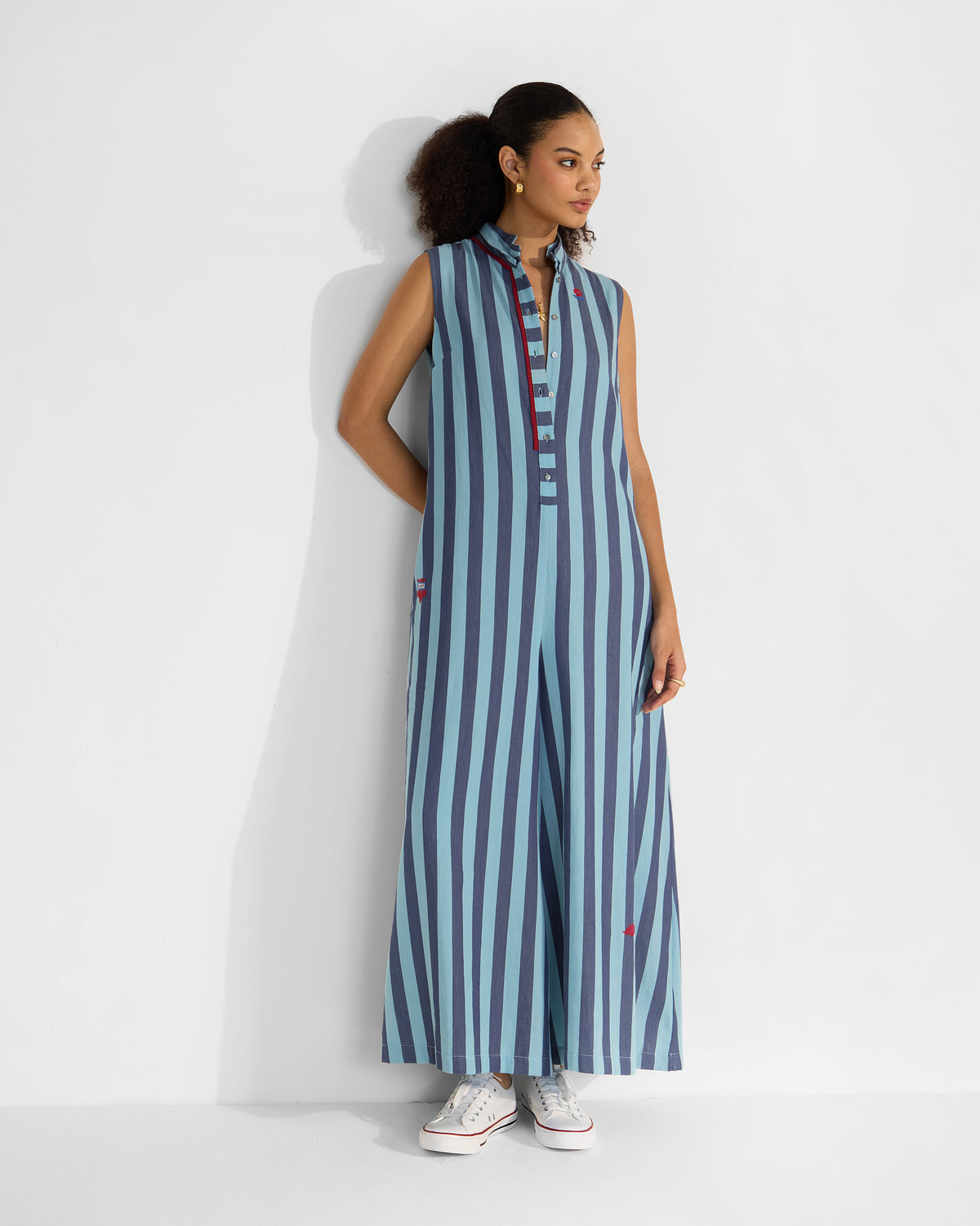 Person wearing a sleeveless blue stripe Bargi jumpsuit.