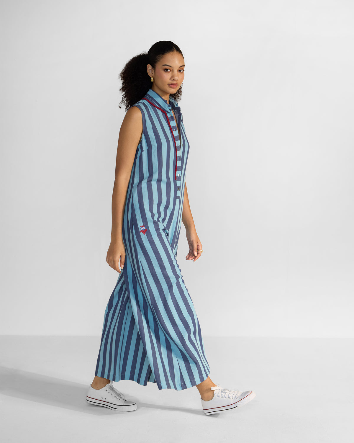 Side view of a blue stripe Bargi jumpsuit with wide legs.