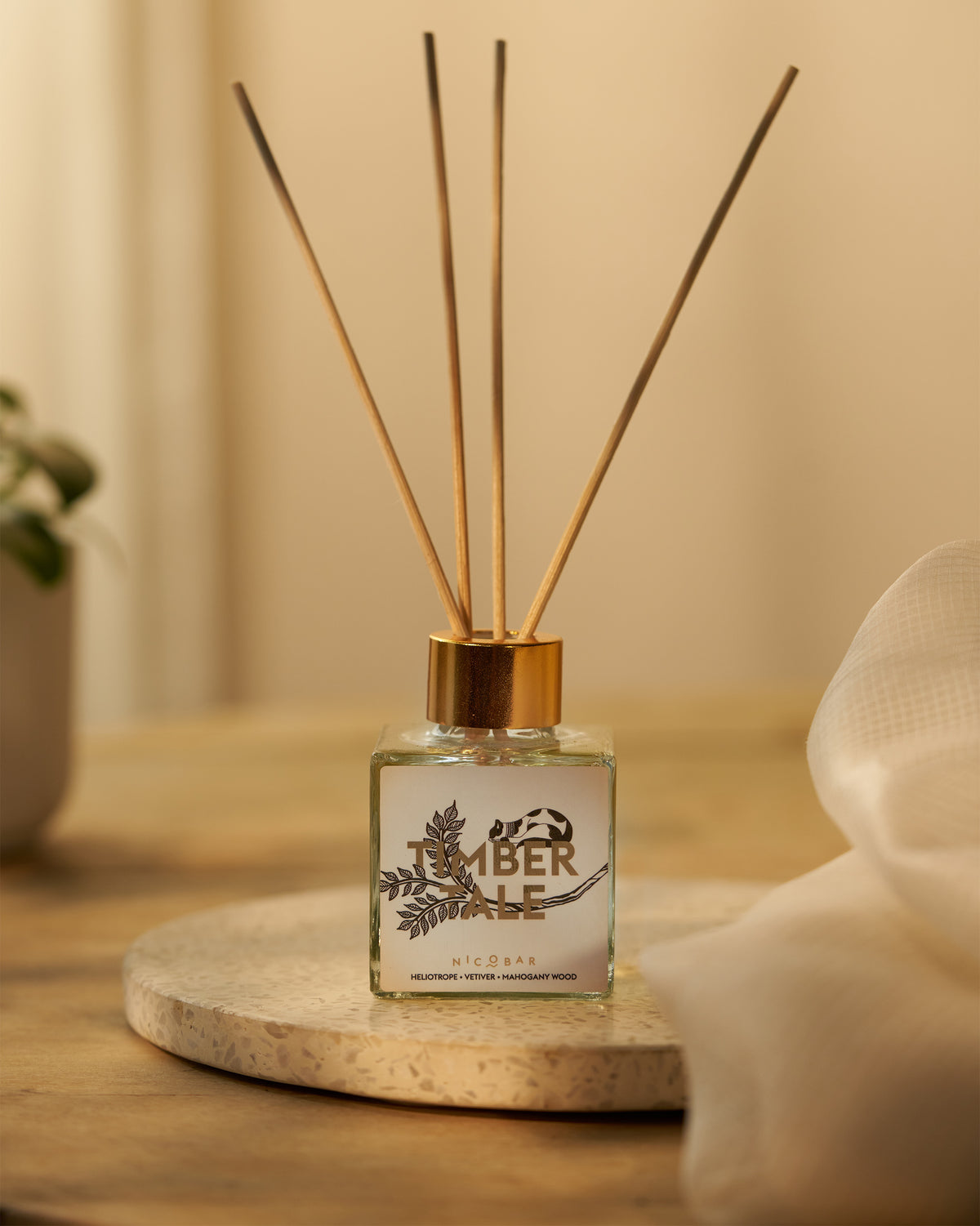 Timbertale Reed Diffuser on a stone tray with its reeds standing up.