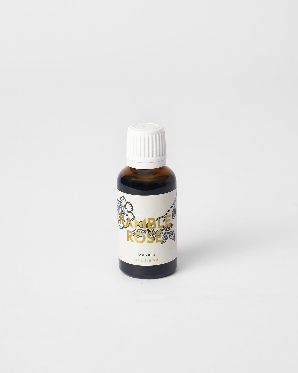 Amber Ramblerose oil vial labeled rose and plum.