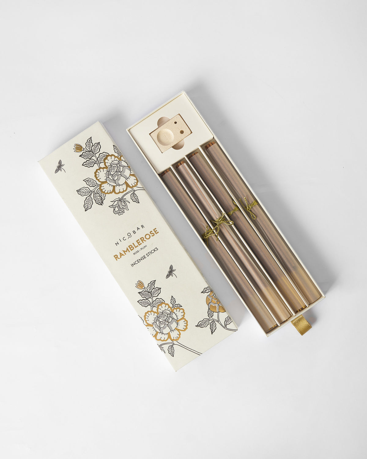 Open Ramblerose incense box showing stick bundles and ceramic holder.