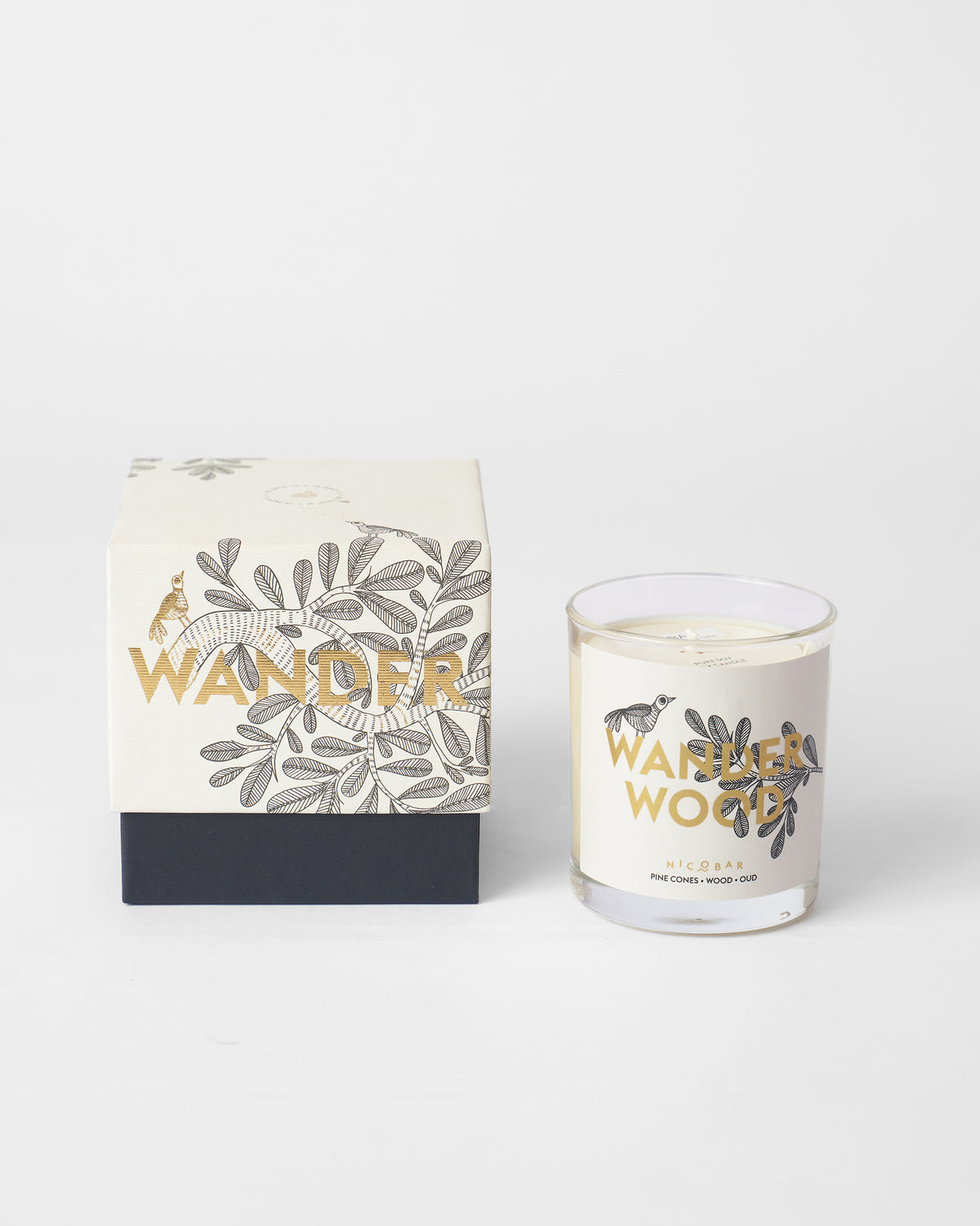 Wanderwood candle in front of its matching botanical gift box.