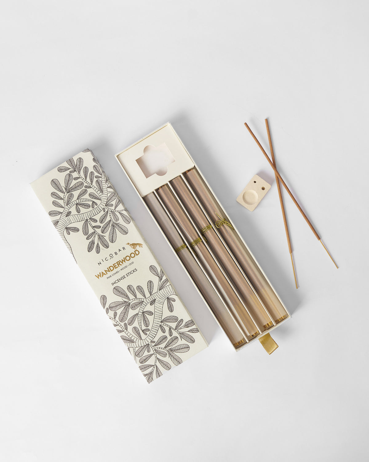 Wanderwood incense sticks with wrapped bundles and a wooden holder.