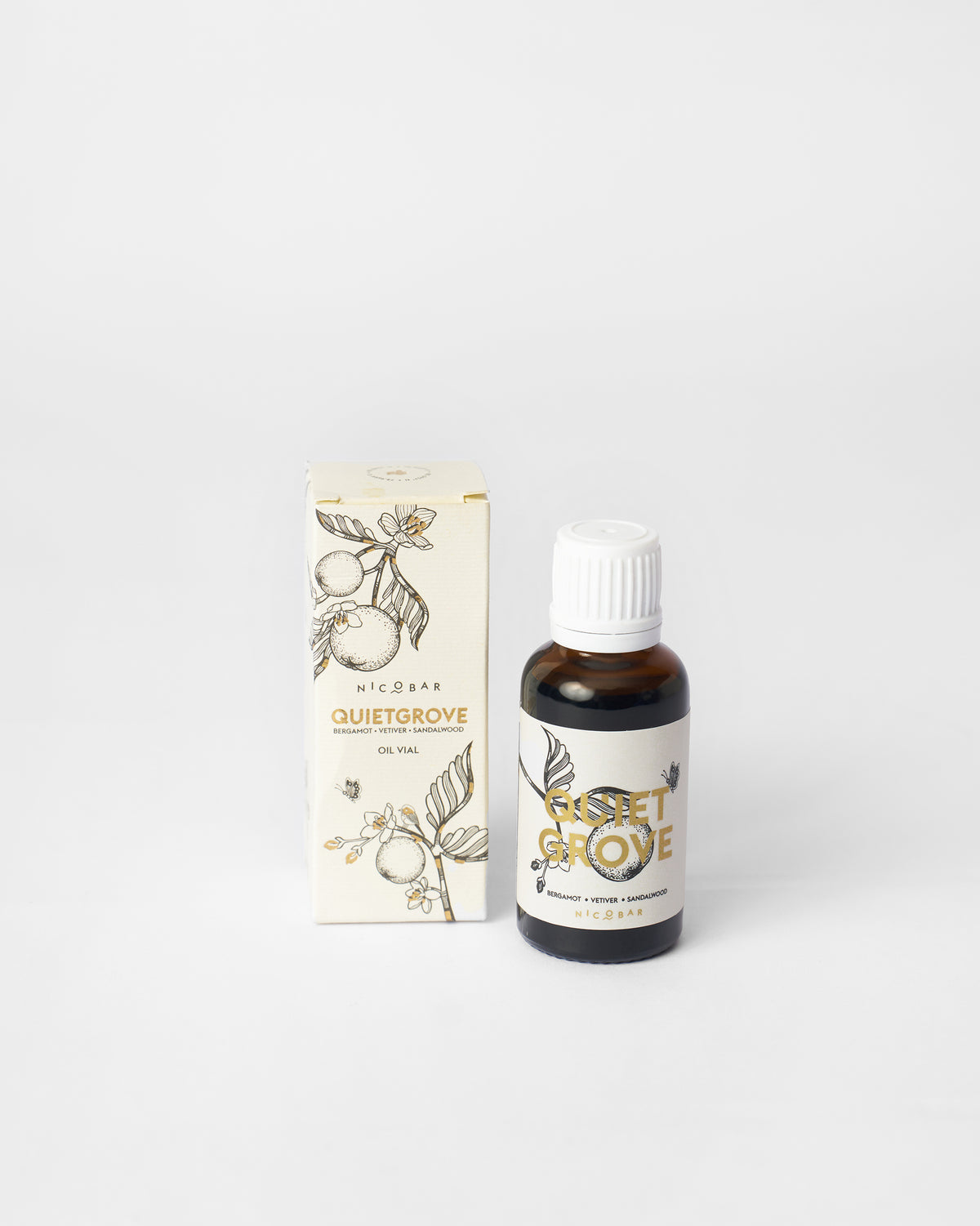 Quiet Grove oil vial beside its cream Nicobar packaging box.