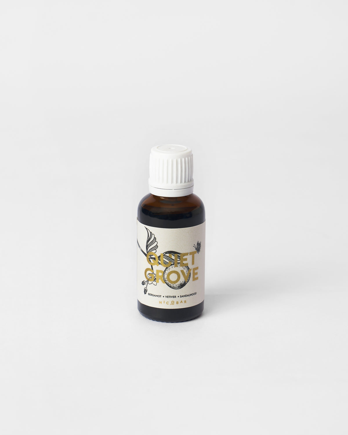 Amber Quiet Grove oil vial labeled bergamot, vetiver and sandalwood.