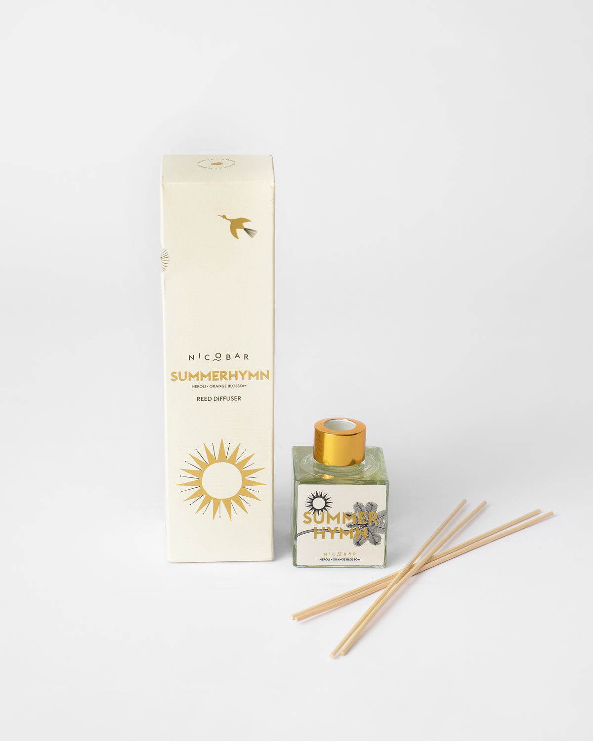 Summer Hymn reed diffuser shown with its cream gift box and reeds.