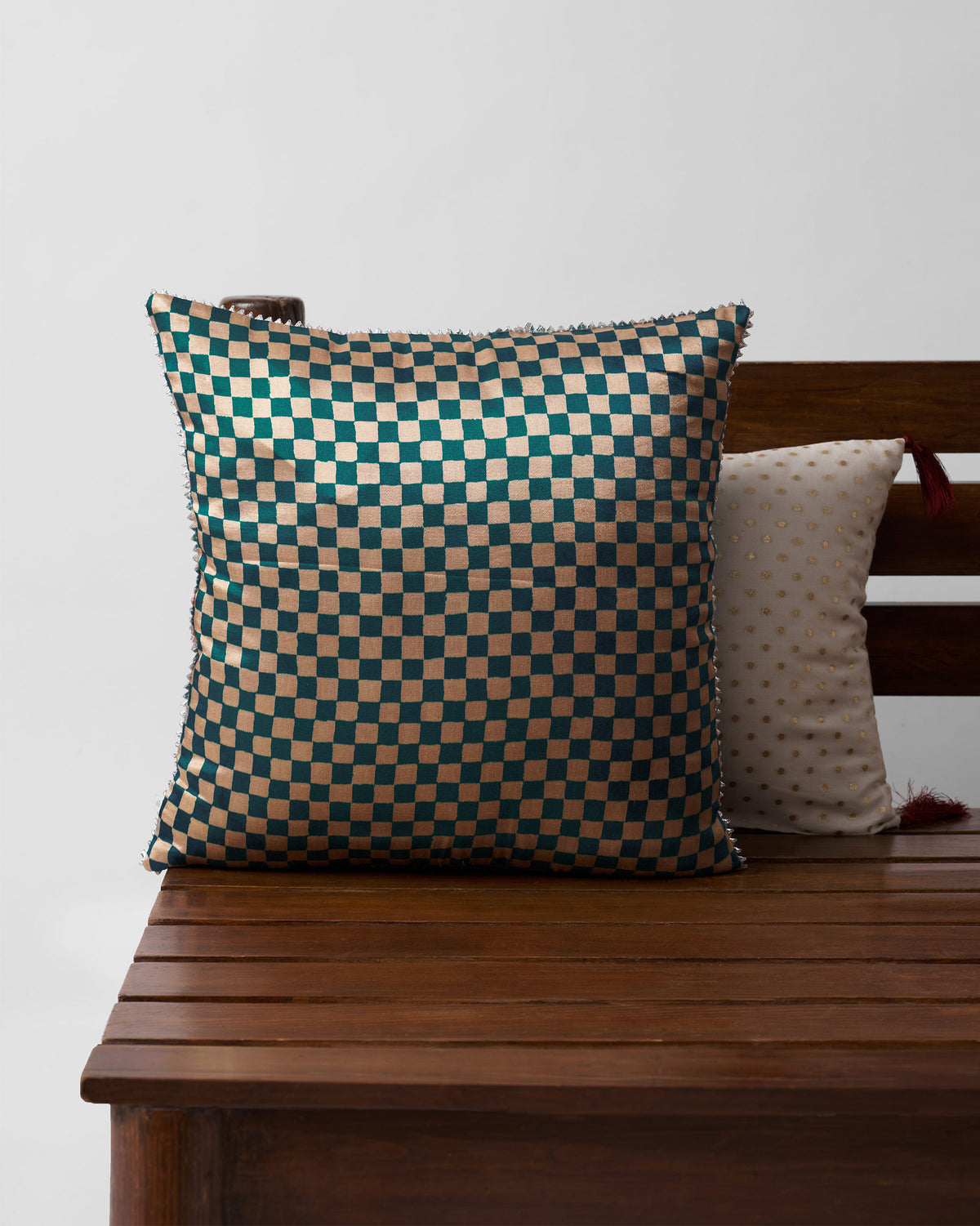 Back of a Tusk Cushion Cover with a teal and cream check pattern.