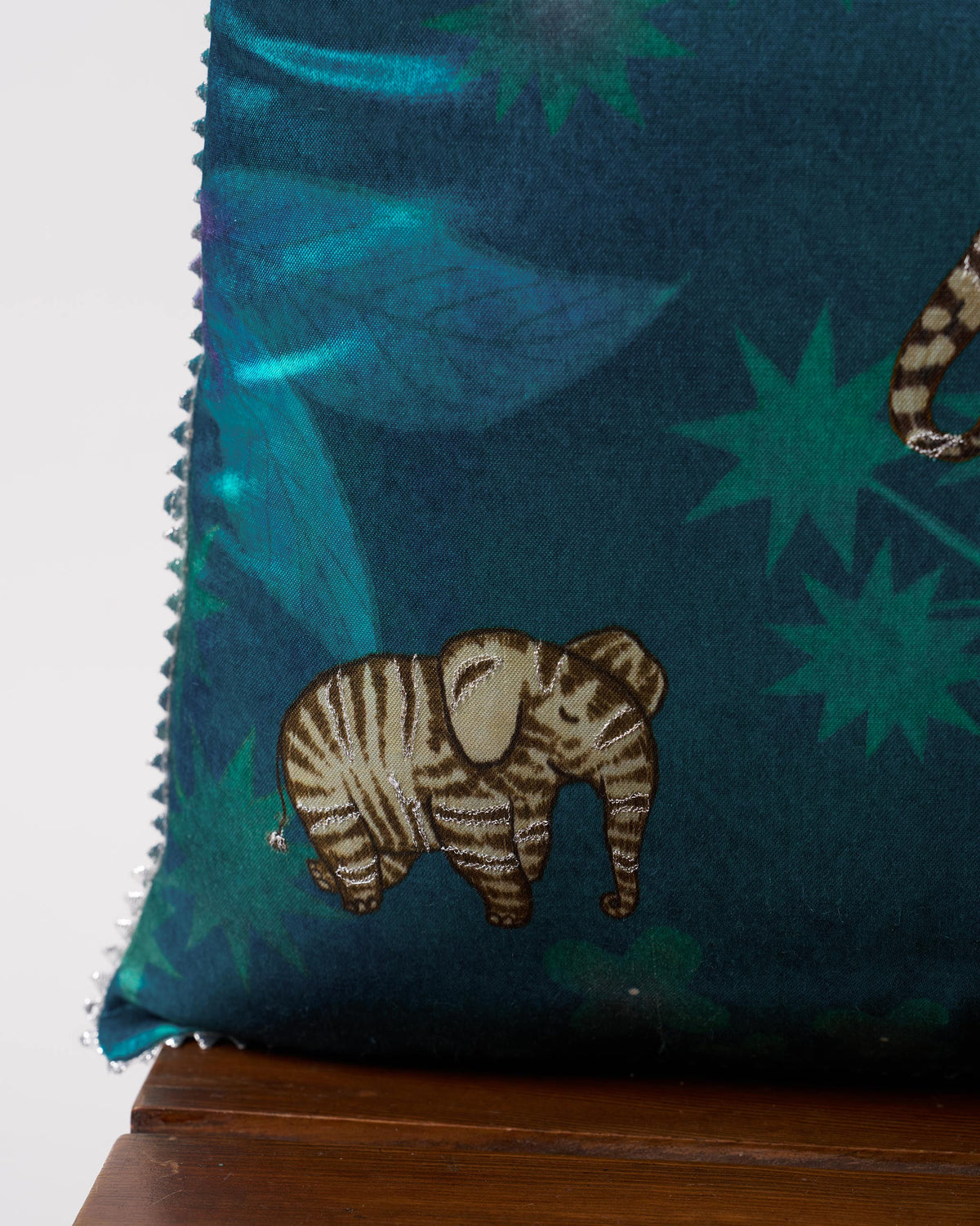 Close-up of a Tusk Cushion Cover showing a striped elephant motif.