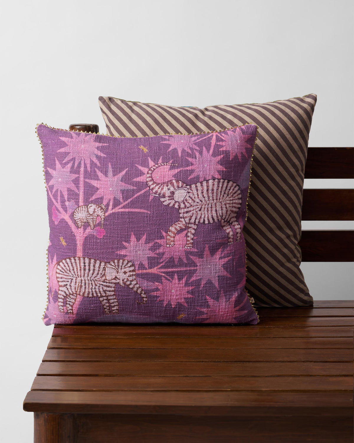 Tusk Bloom Cushion Cover with zebra and star flower motifs in purple.