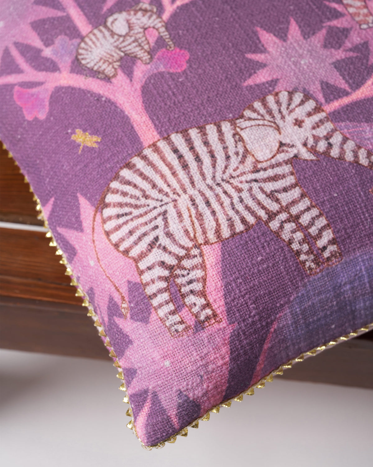Corner of a Tusk Bloom Cushion Cover showing a zebra and pink star motifs.