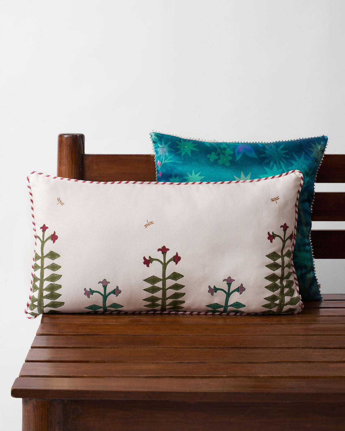 Blooming Mogra cushion cover with floral stalks and red-and-white Kandy piping.