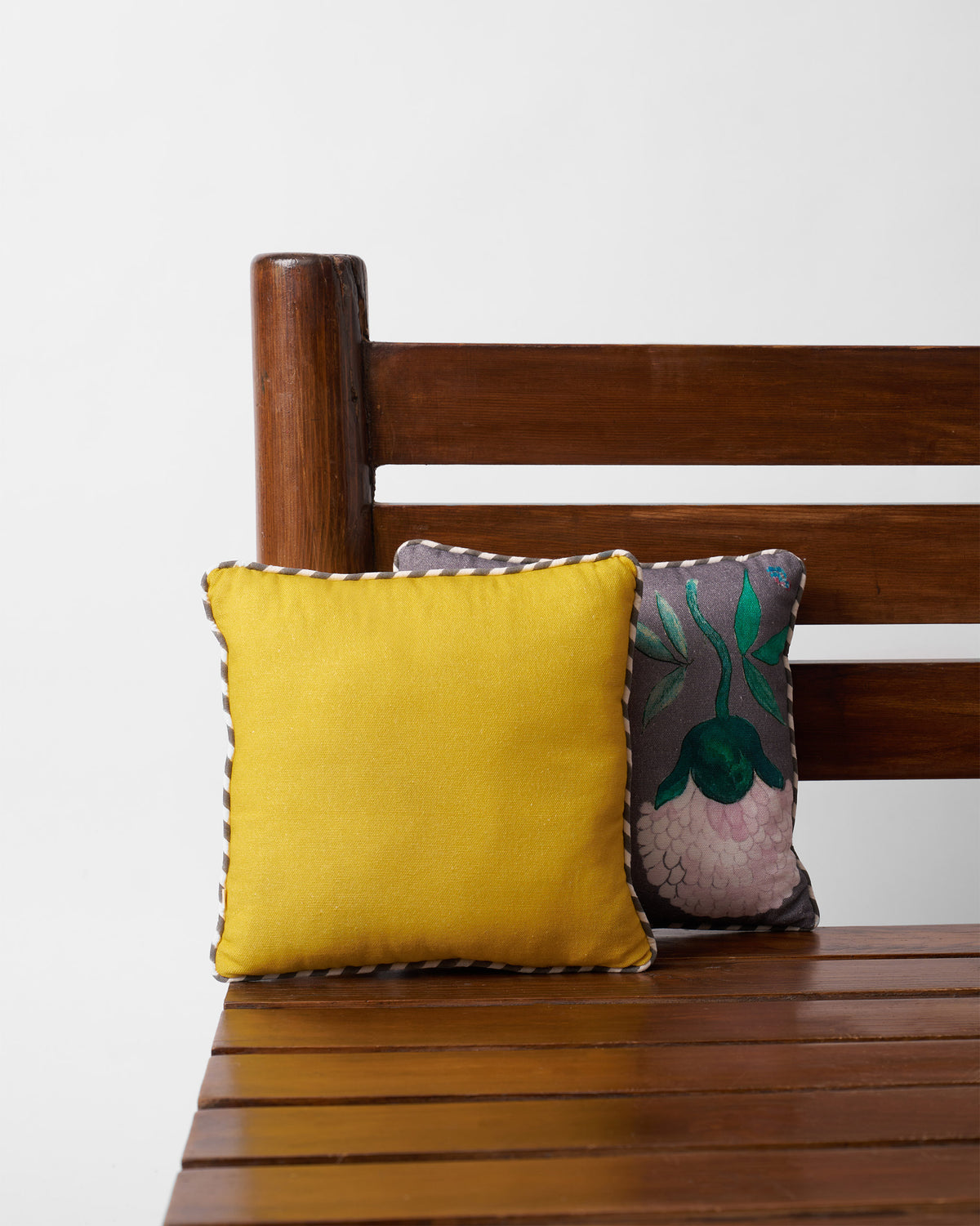 Plain yellow Winter Wonderland Car Cushion with a striped piped edge.