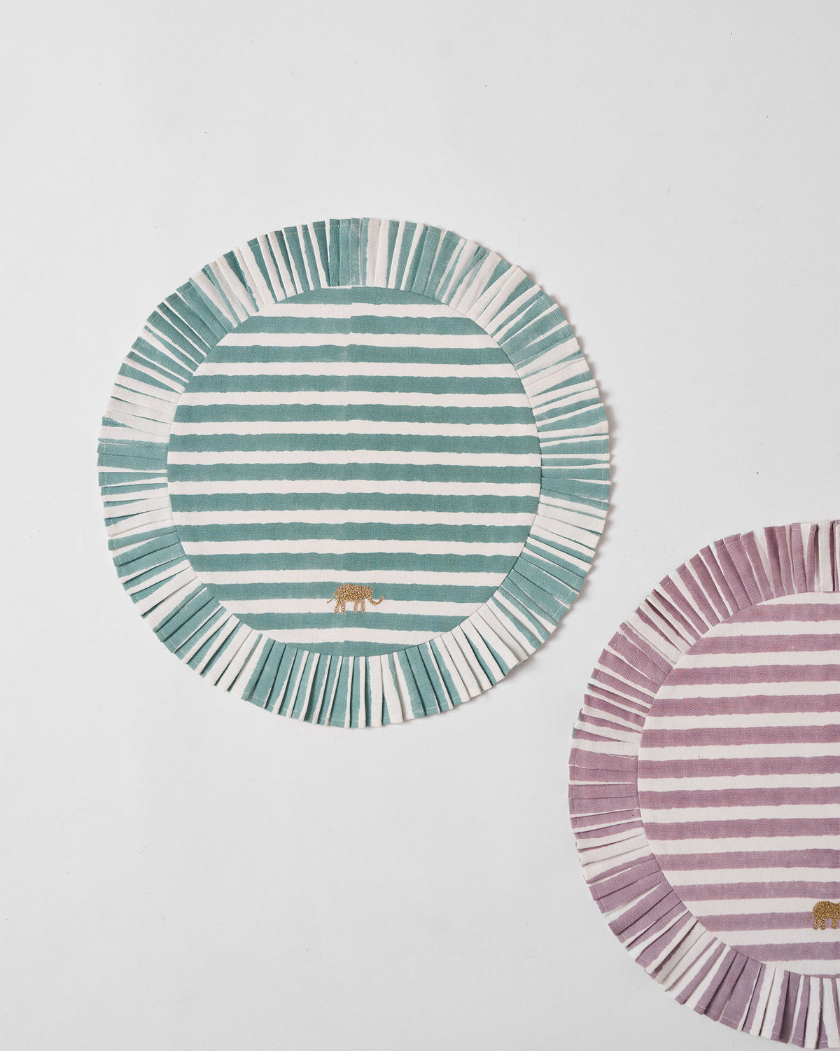 Teal and white striped Yamuna placemat with a gold embroidered elephant.