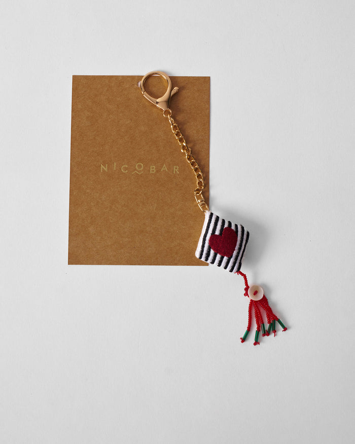 Dil charm keychain with a red heart on a striped cube.